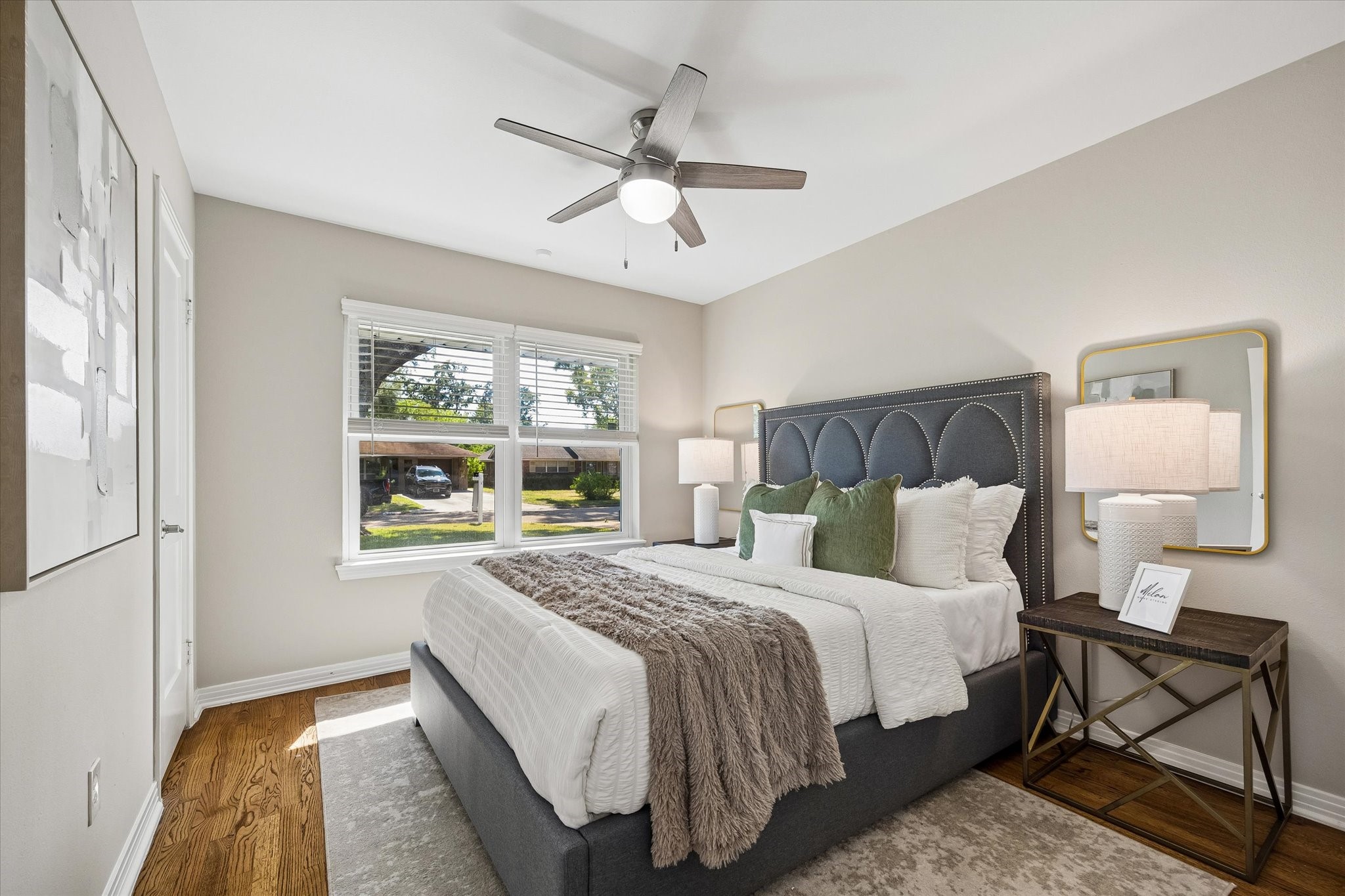 A peaceful primary retreat featuring beautiful hardwood floors and abundant natural light.