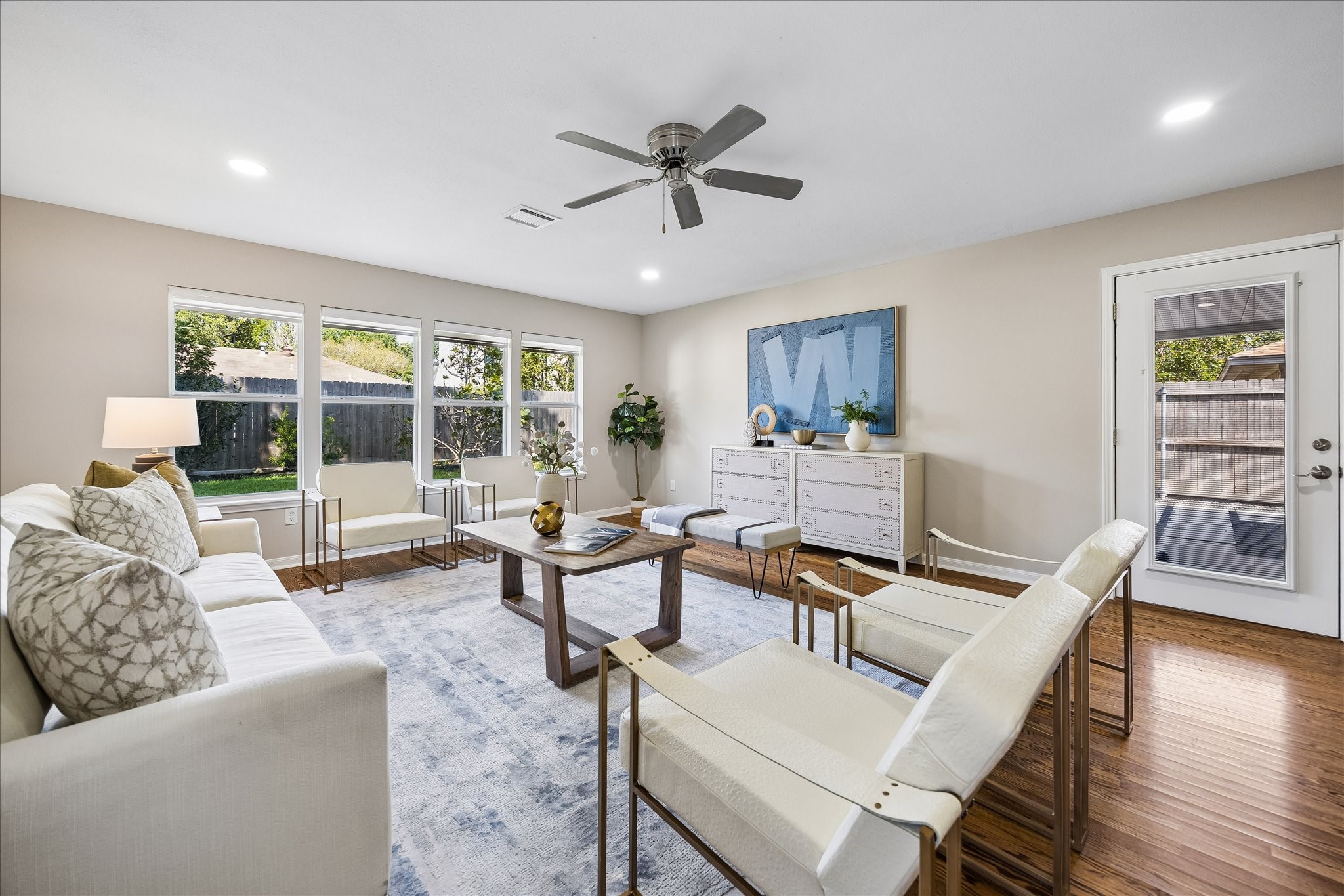 Beautiful natural light and tranquil backyard views elevate this versatile gathering space.