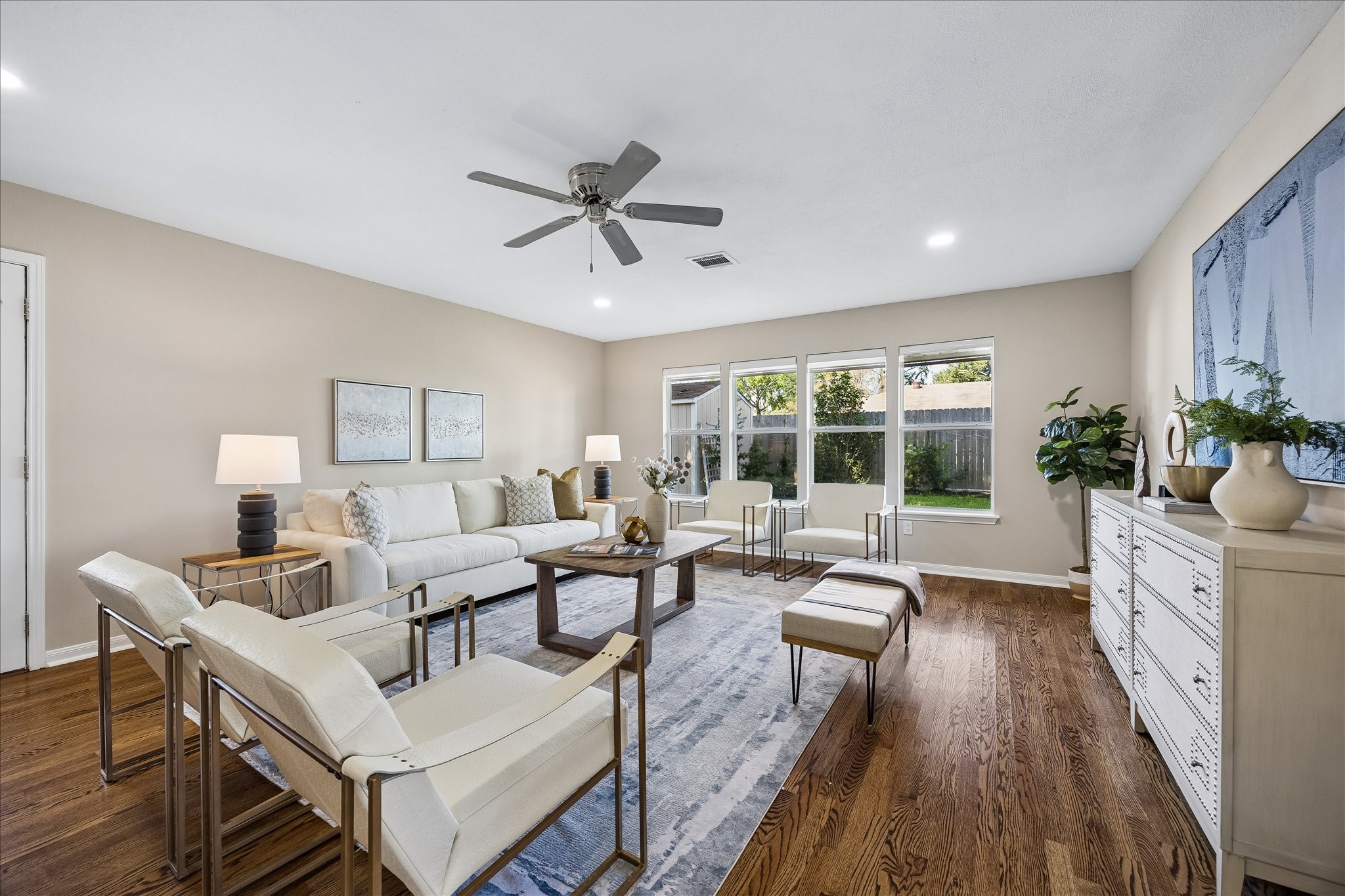 An expansive family room framed by oversized double-pane windows overlooking the backyard.