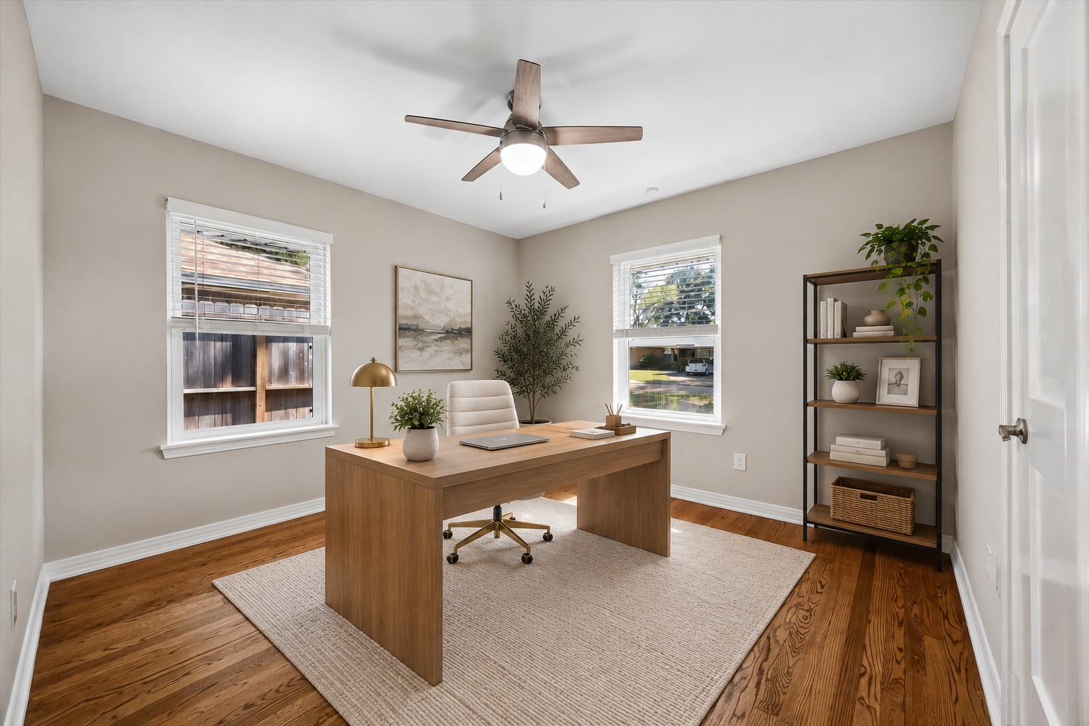 A bright, versatile bedroom thoughtfully envisioned as a stylish home office. This photo has been virtually staged.