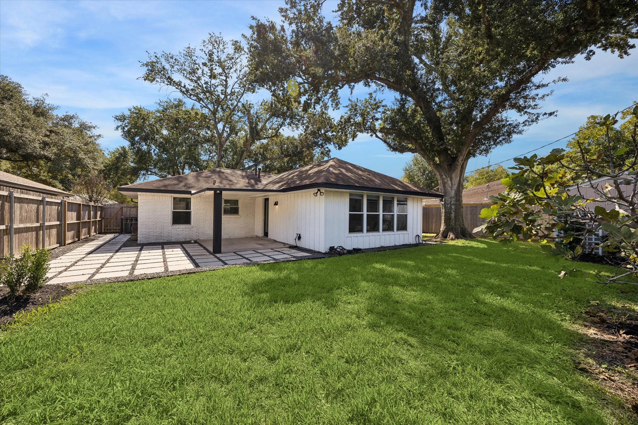 A generous backyard with lush green space, mature trees, and room to enjoy the outdoors.