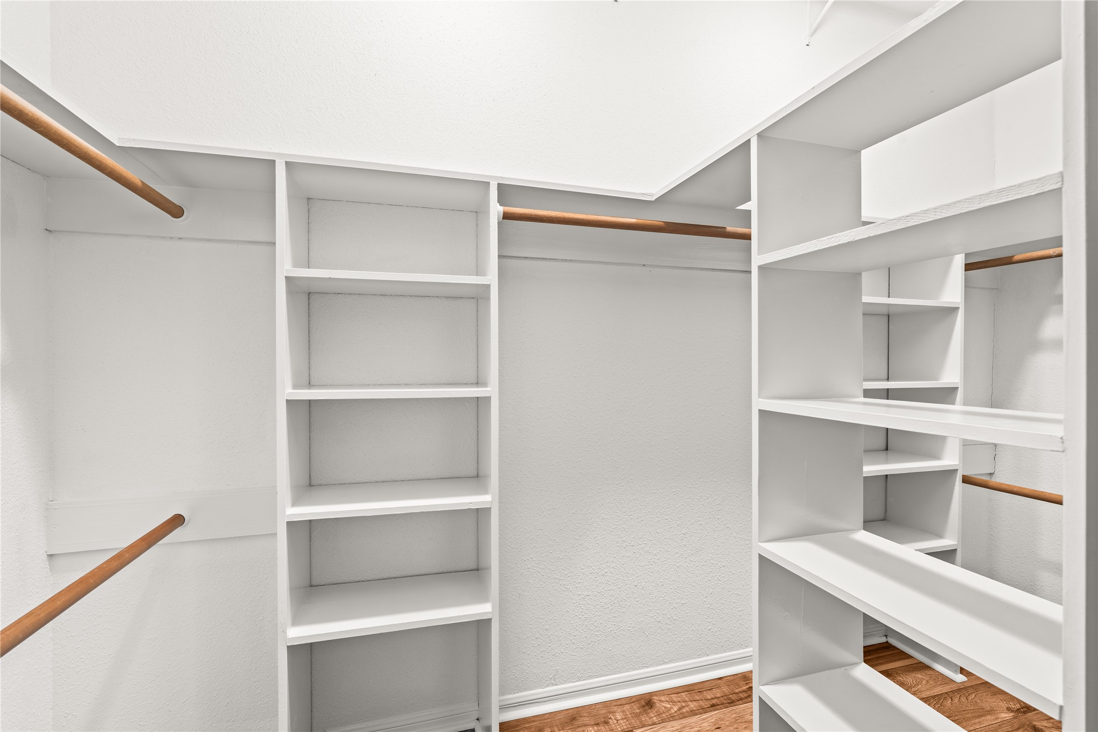 Built-in shelving, dedicated hanging space, and an organized layout make the walk-in closet as functional as it is spacious.