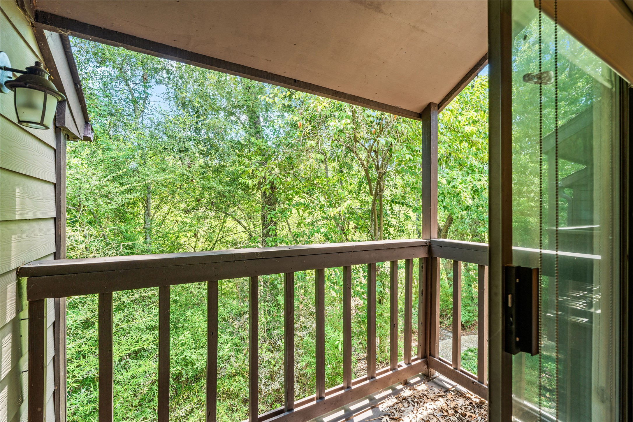 Step outside to your private covered balcony, where mature trees create a peaceful backdrop for your morning coffee or evening unwind.