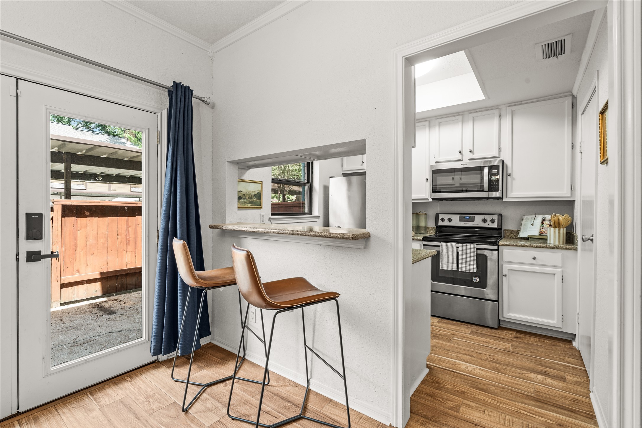 Extra seating at the breakfast bar adds everyday functionality while keeping the kitchen open to the dining area.