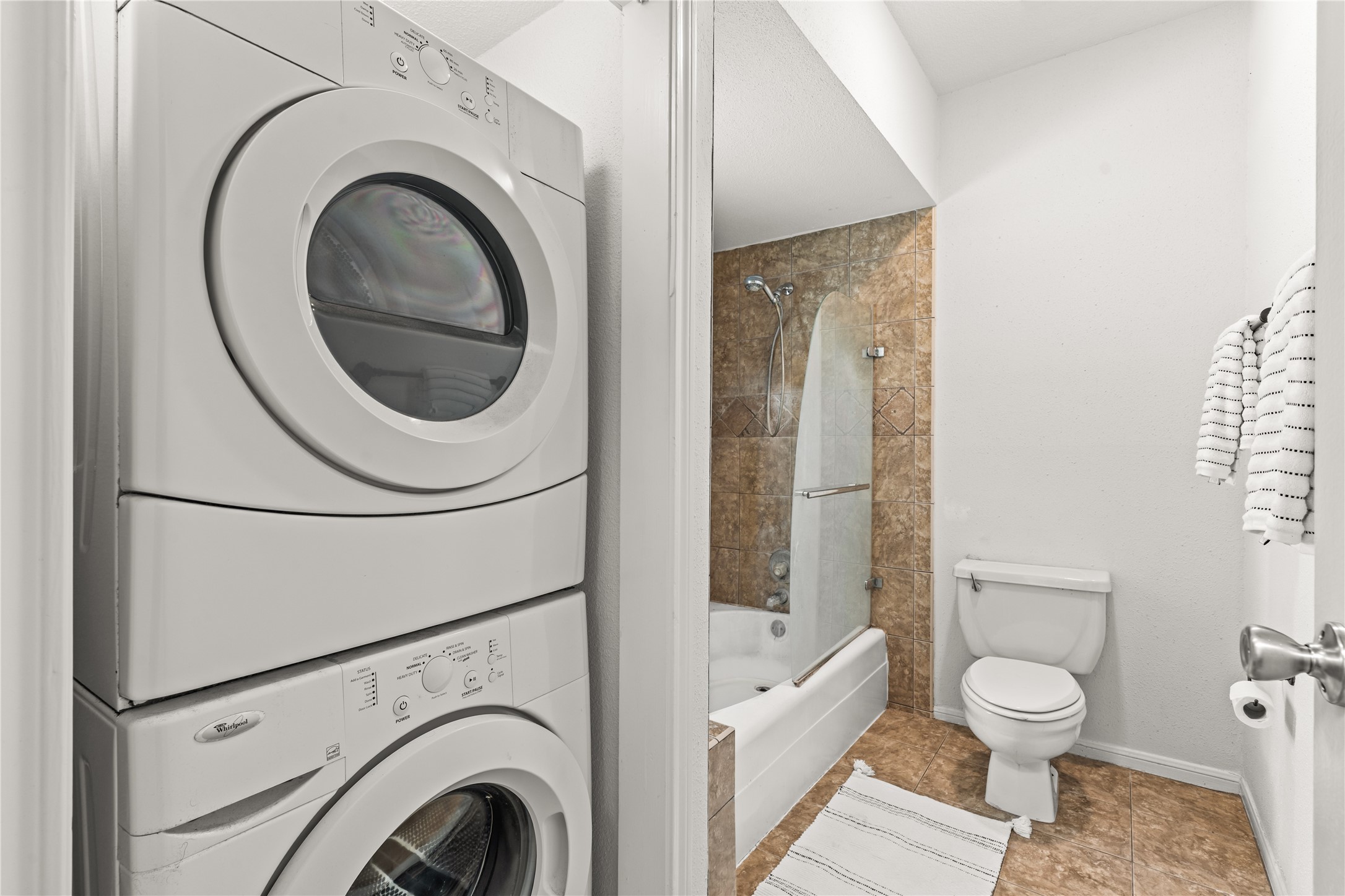 The primary bath is paired with a full-size, in-unit laundry area, keeping everyday essentials close at hand.
