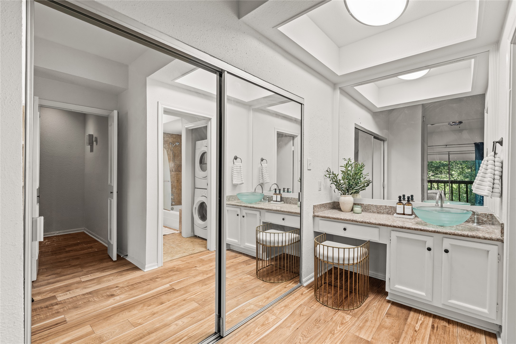 The primary suite pairs generous closet space with a dedicated vanity, making busy mornings feel a little more organized.