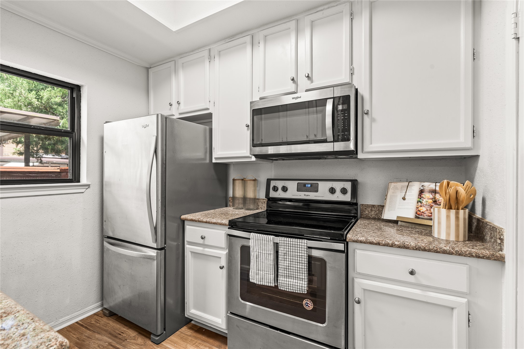 A practical layout, plentiful cabinetry, and stainless steel appliances make the kitchen as functional as it is inviting.