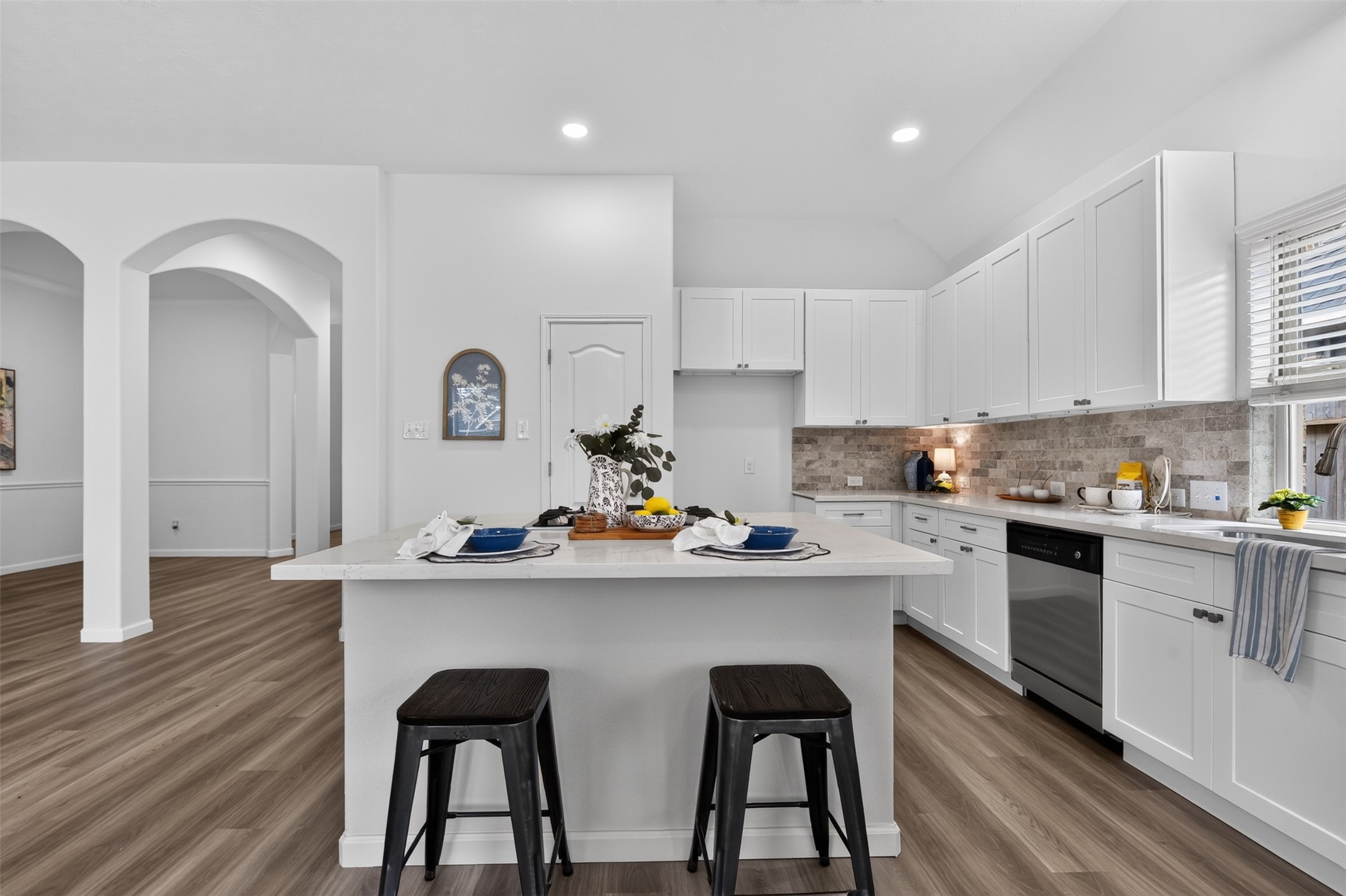 An abundance of recently updated contemporary cabinets and new stone backsplash.