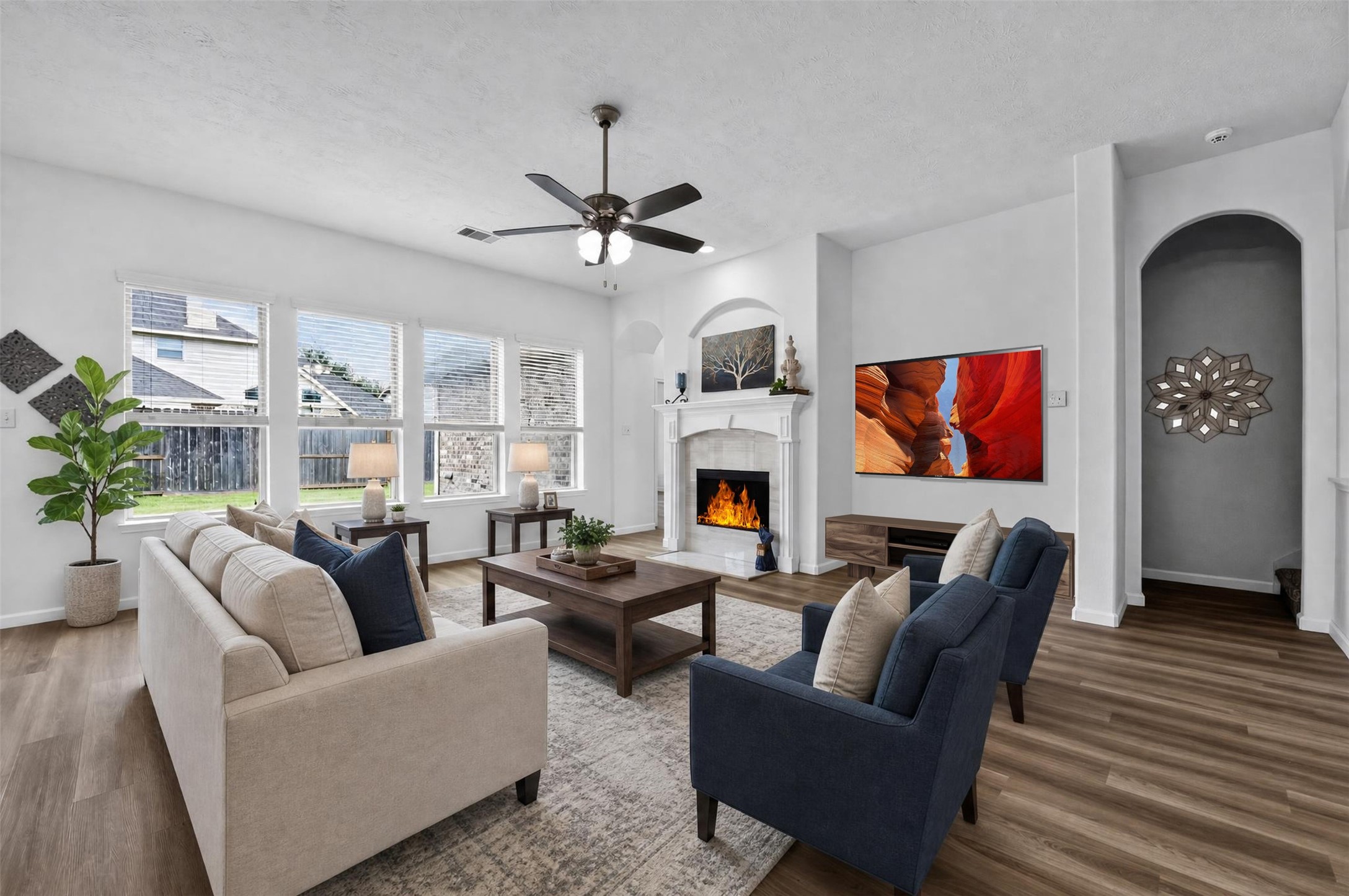 Beautiful waterproof luxury vinyl plank floors throughout the main living spaces. The living room boasts a wall of windows for an abundance of natural light when desired. [*Photo has been virtually staged to offer design and layout ideas.]
