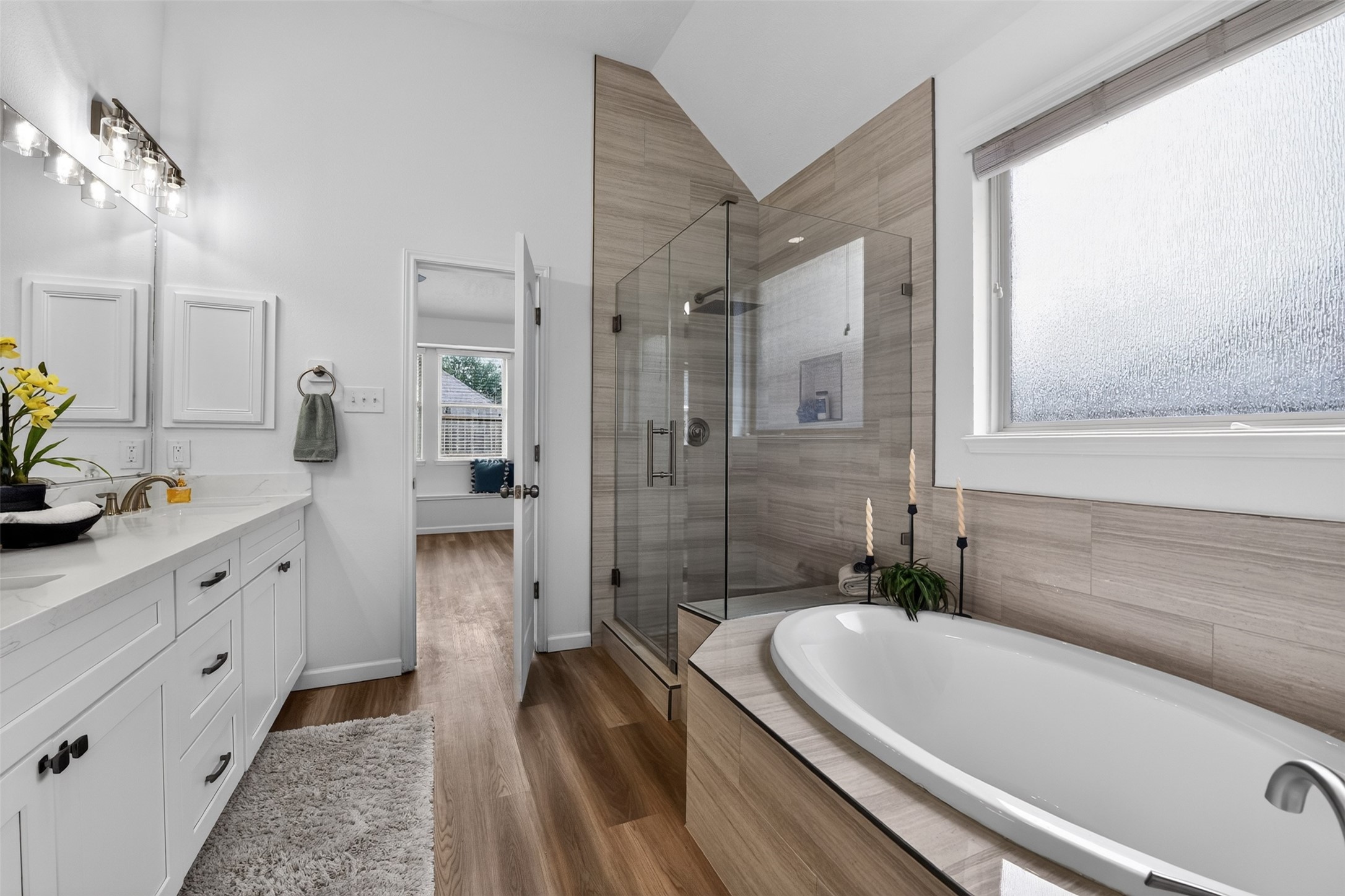 Enjoy the luxurious 'garden' soaking tub next to the spacious oversized new walk-in shower. Opaque privacy window allows plenty of natural light without sacrificing privacy.