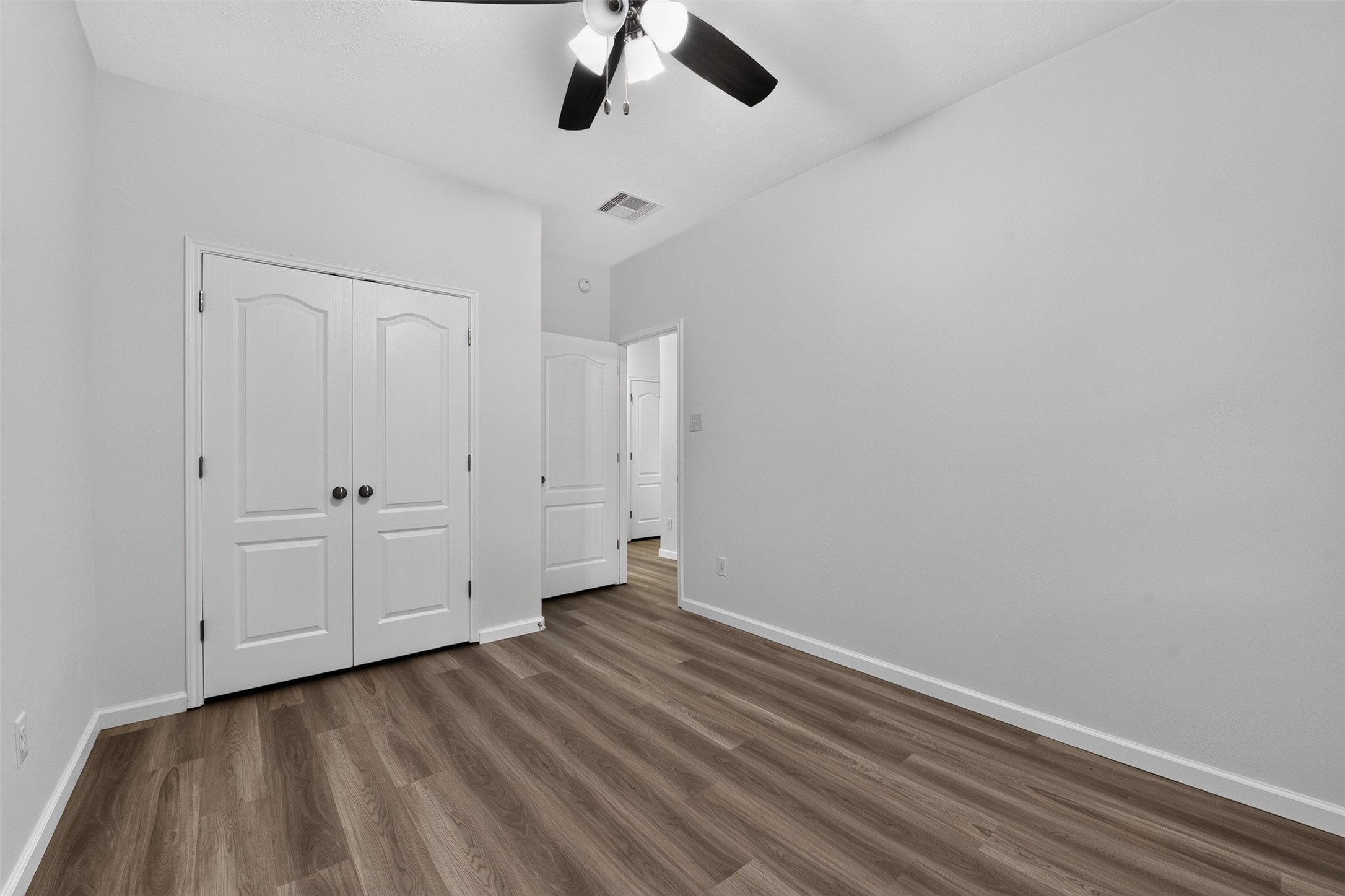 3rd Bedroom with new flooring and ceiling fan.