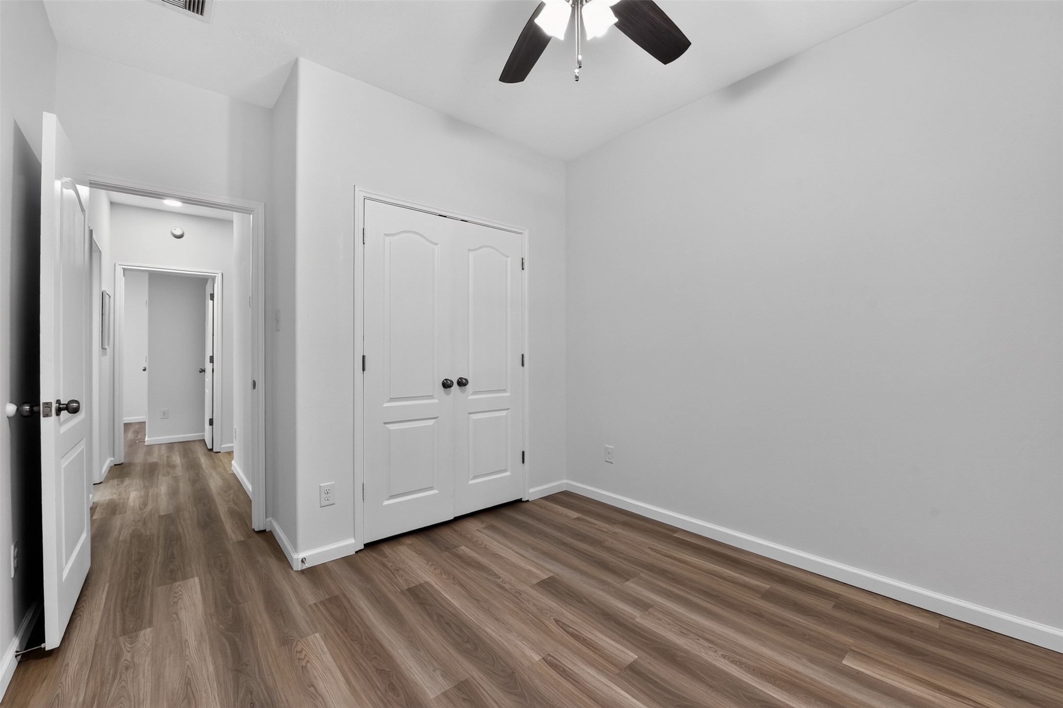 4th Bedroom with new flooring and ceiling fan.
