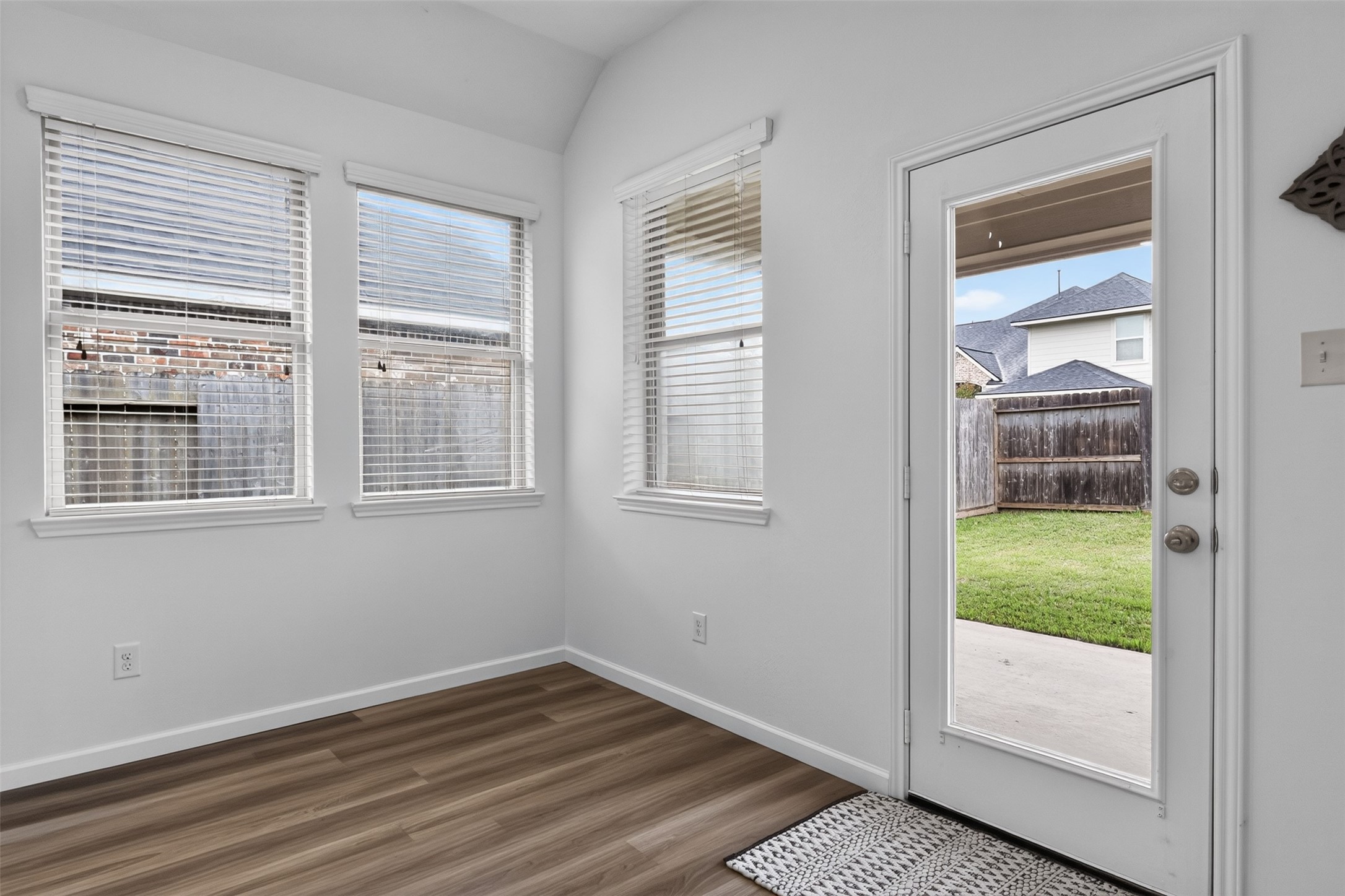 Breakfast area with plenty of natural light, windows have blinds, and great views of the backyard. Patio access too.