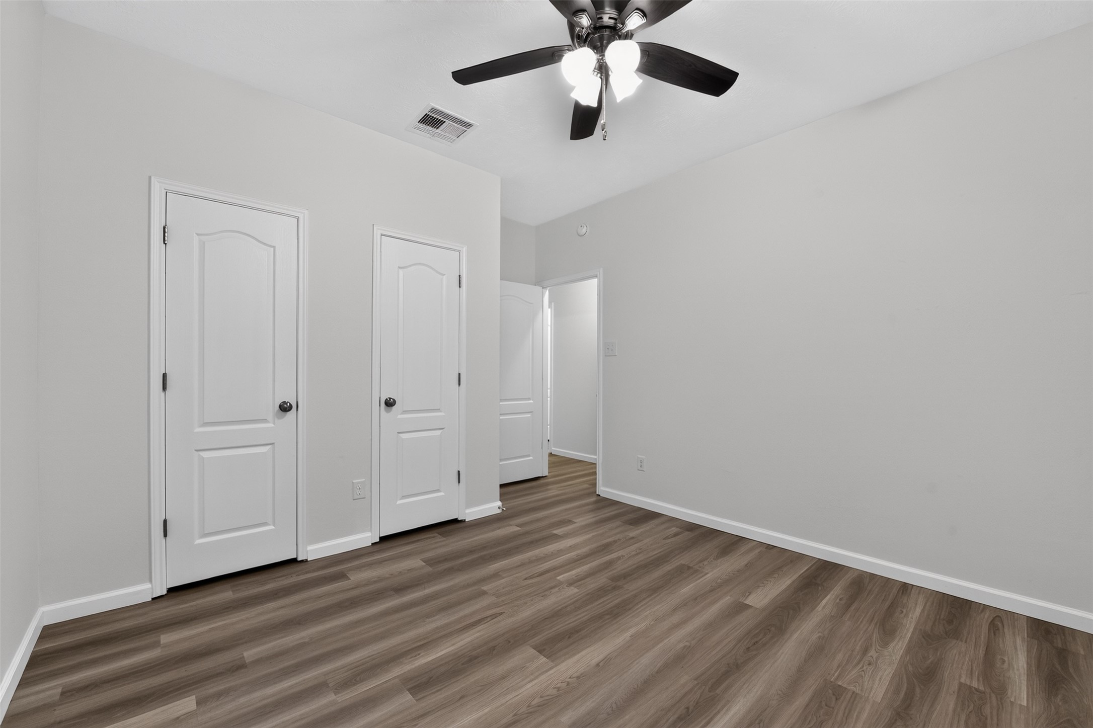 2nd Bedroom with new flooring and ceiling fan.