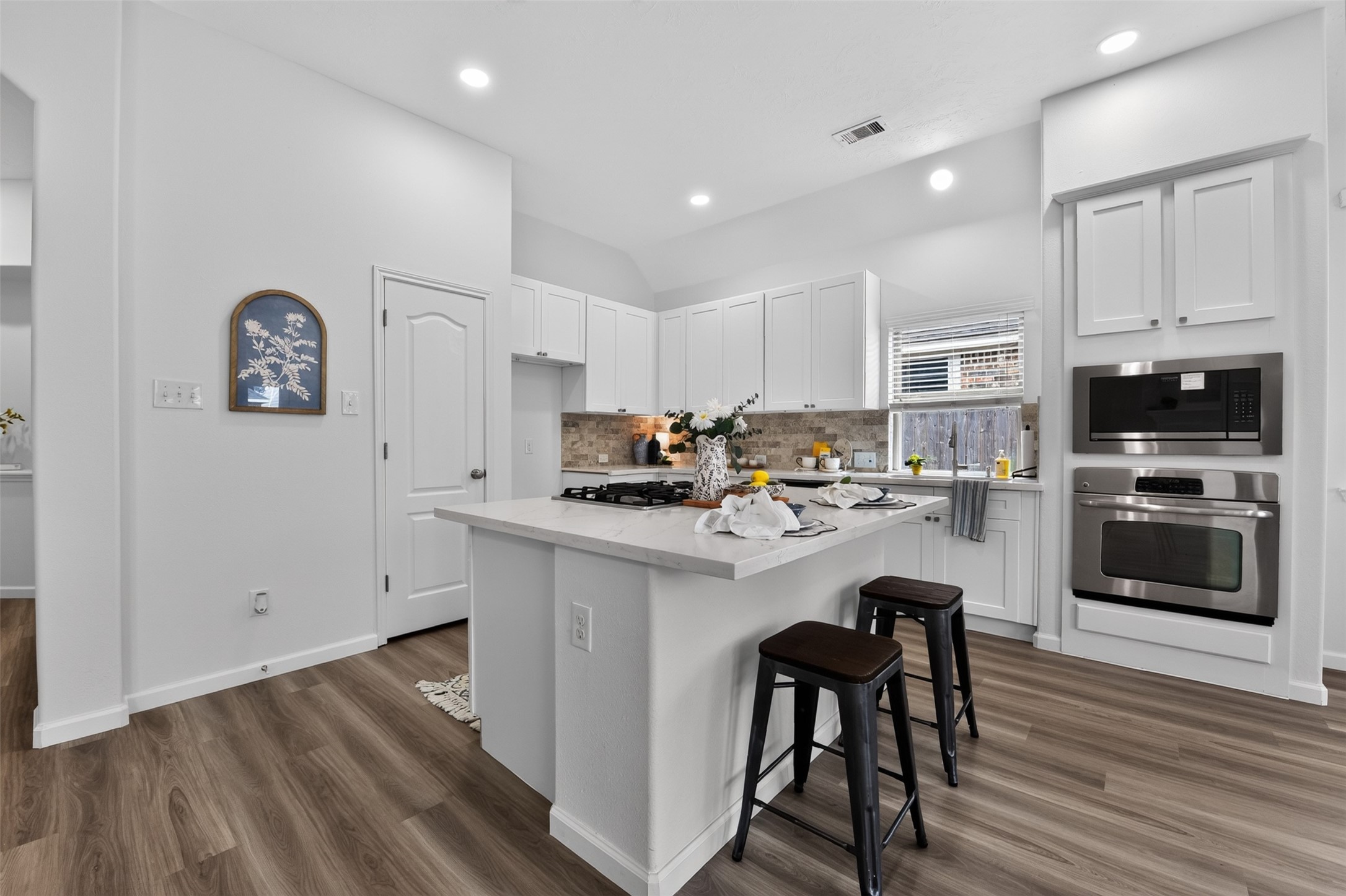 Kitchen with new Quartz countertops plus a large island with space for adding your own bar stools to create additional seating space.