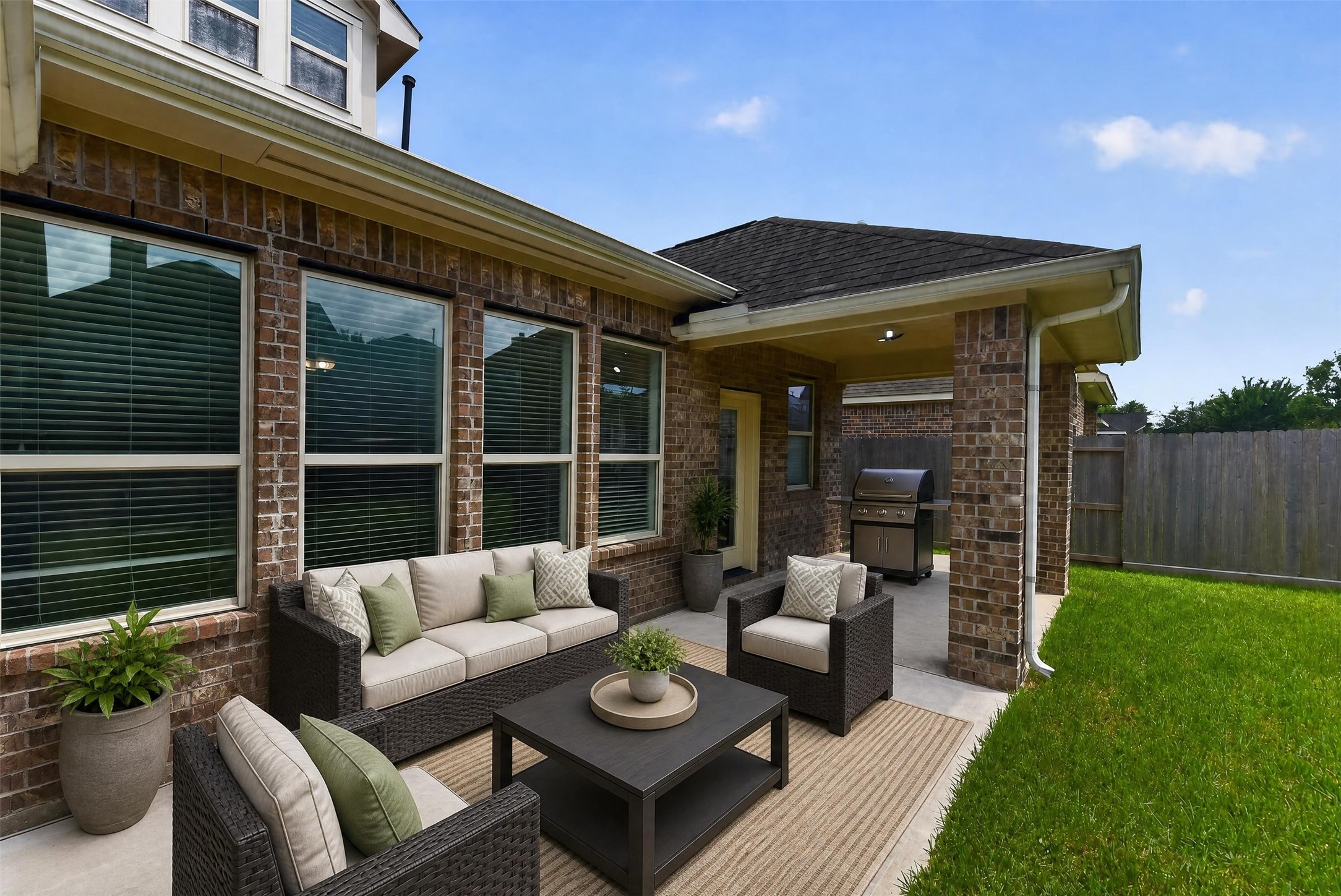 Extended patio overlooks the nicely sized backyard. [*Photo has been virtually staged to offer design and layout ideas.]