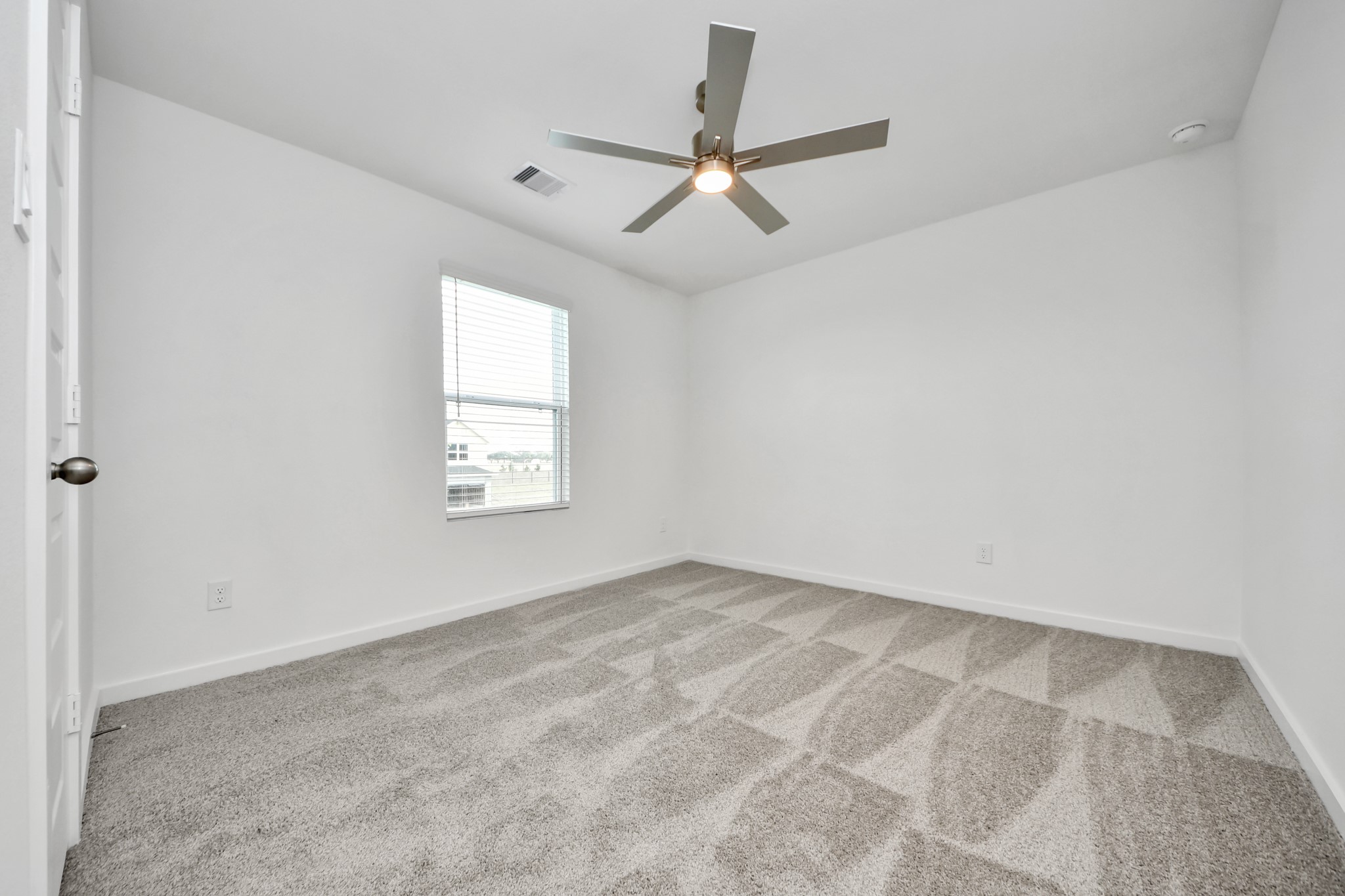 Secondary bedroom features plush carpeting, large windows that let in plenty of natural light, bright paint, and spacious closets. Sample photo of completed home with similar floor plan. Actual colors and selections may vary.