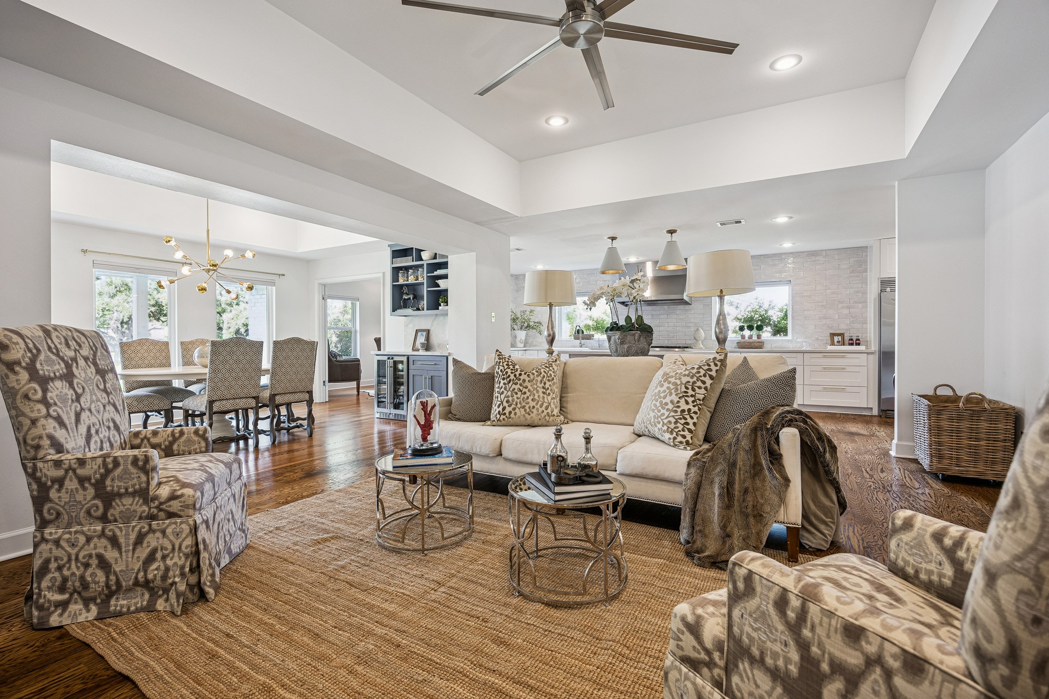 The spacious 20' x 16' living room offers open
views into the dining room and kitchen, creating a seamless, entertainer-friendly layout ideal for
everyday living. Anchored by hardwood floors throughout, this inviting floor plan is perfect for gathering with family and friends or enjoying a quiet evening at home. Recessed lighting, a ceiling fan, and neutral designer paint complete the warm and welcoming atmosphere.