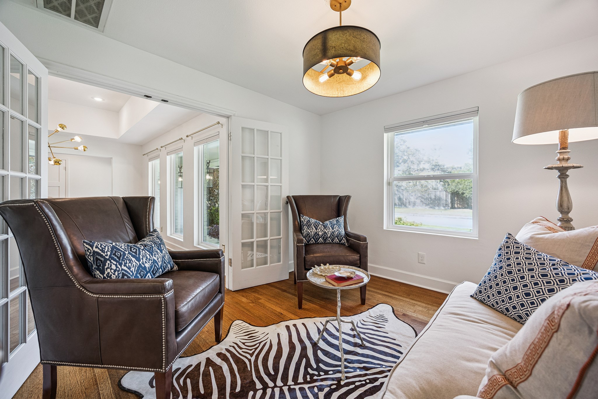 Tucked just off the dining room, this intimate sitting area offers flexibility to suit your lifestyle. A large window brings in natural light while French doors provide separation from the main living areas.