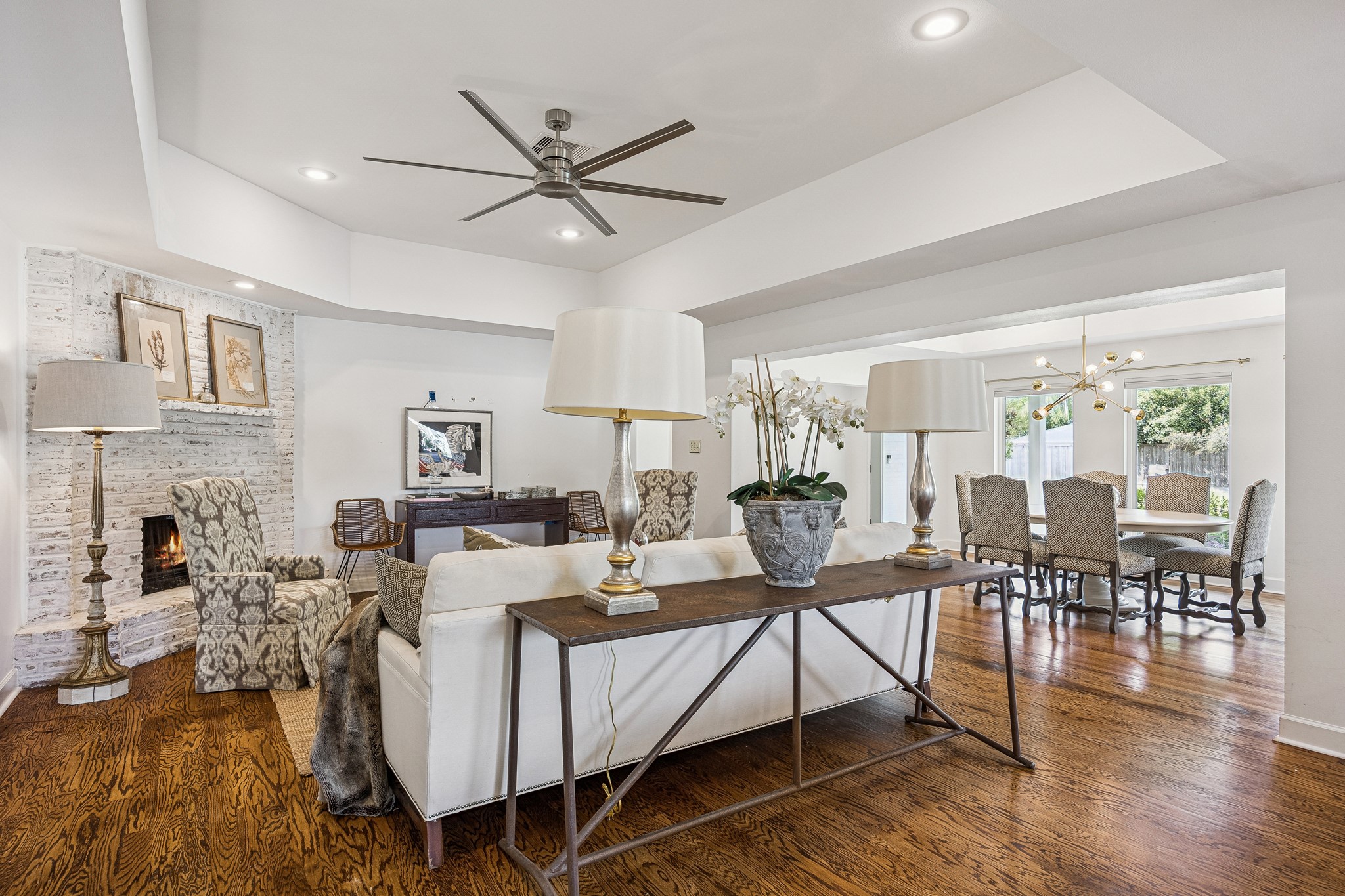 This expansive view highlights the home's seamless connection between the living and dining spaces. Hardwood floors and an open floor plan create a cohesive, welcoming environment.
