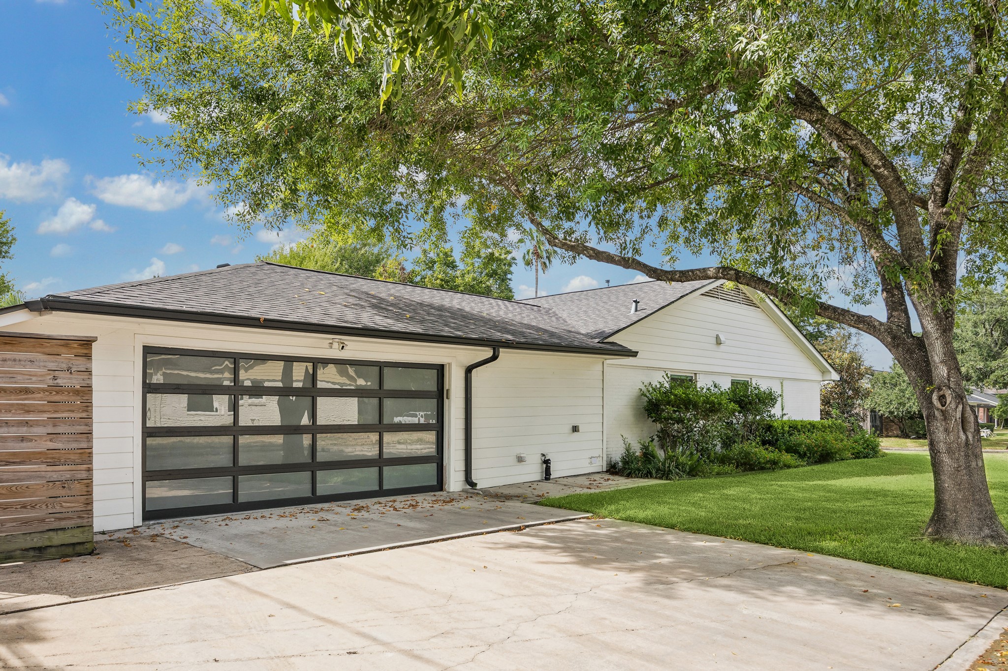 The two-car garage and extra storage space inside, offers convenient access alongside an extended driveway with extra parking. You will definitely enjoy having this corner lot with room for guests staying and large shady trees encompassing the
home.