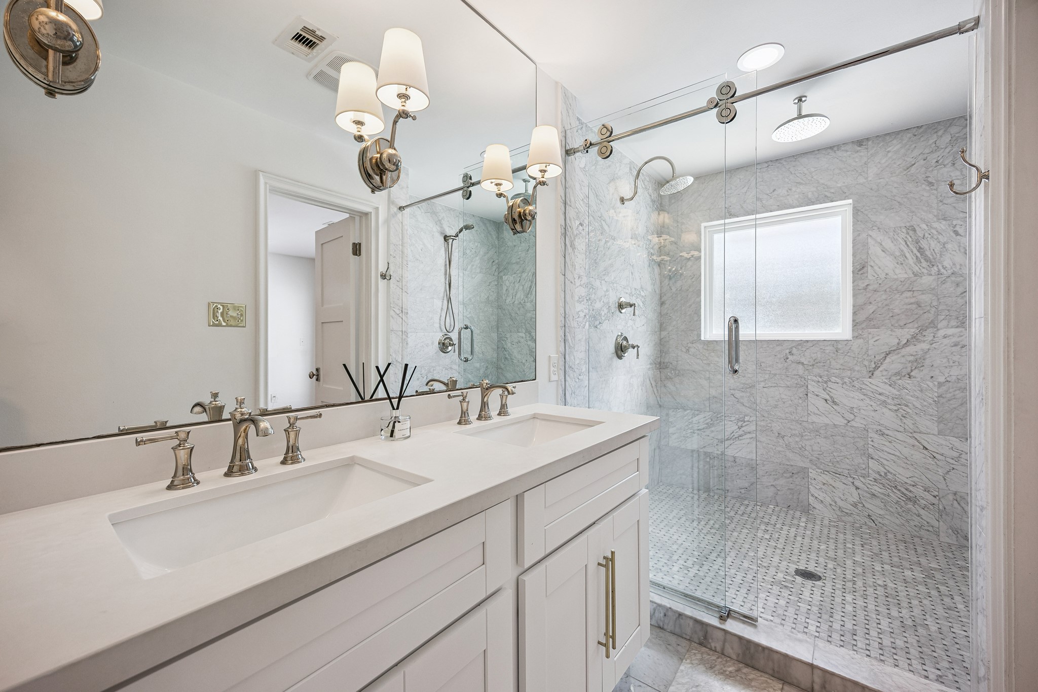 The primary bathroom welcomes you with a
marble-tiled walk-in shower behind a frameless glass enclosure and double sinks with high end
hardware. Enjoy all the luxuries daily in this great primary bathroom!