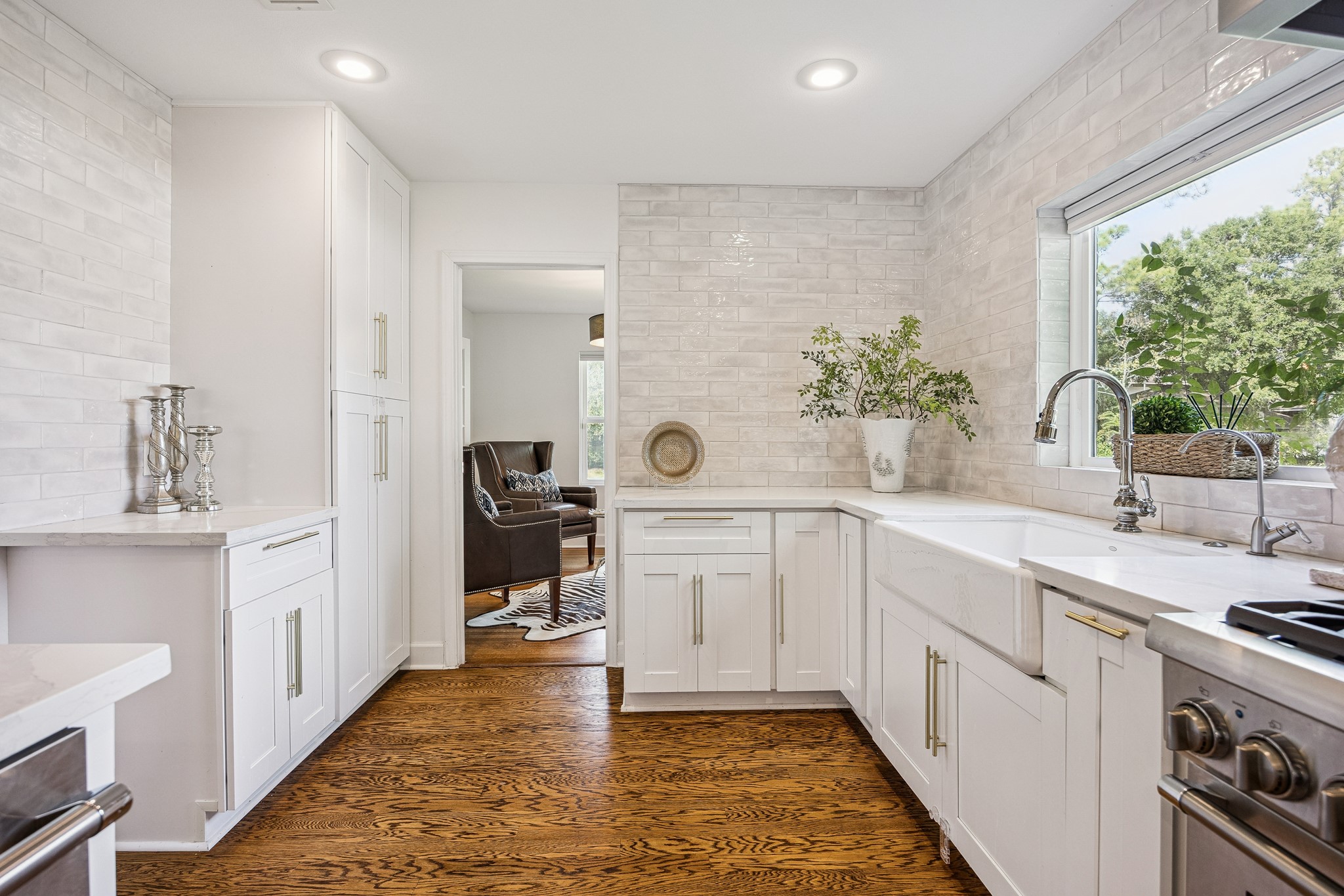 Designed with the home chef in mind, the kitchen offers a professional-style gas range, stainless steel vent hood, and extensive counter space. A functional layout allows for easy movement between cooking, preparation, and dining areas.