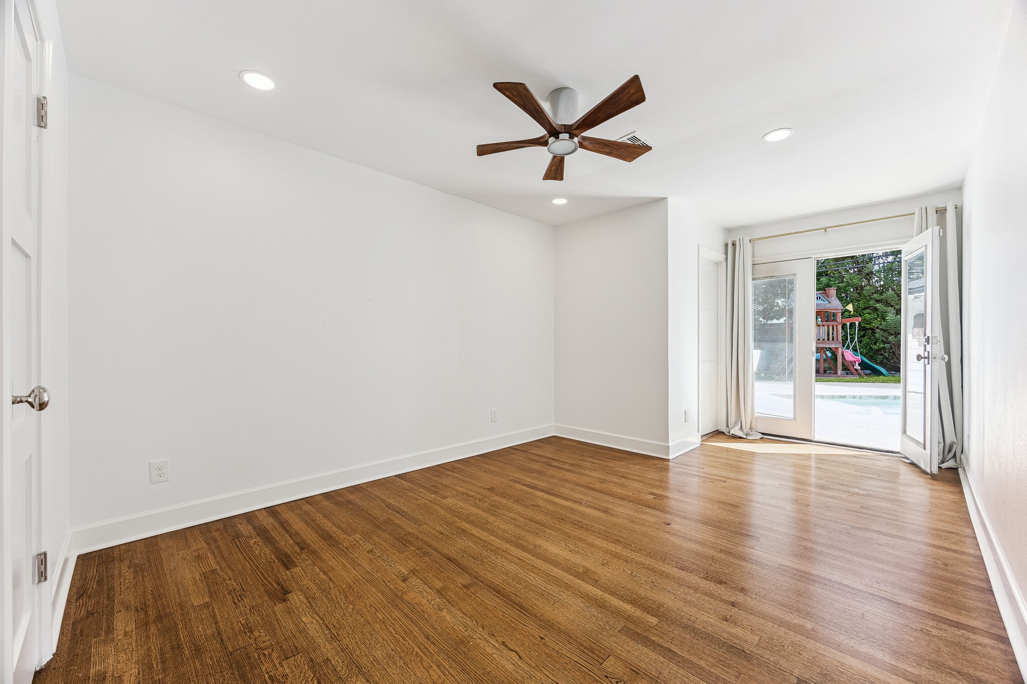 (17x12) French doors invite natural light into this bedroom while allowing you direct access to the pool. The space strikes a refined balance between comfort and sophistication.