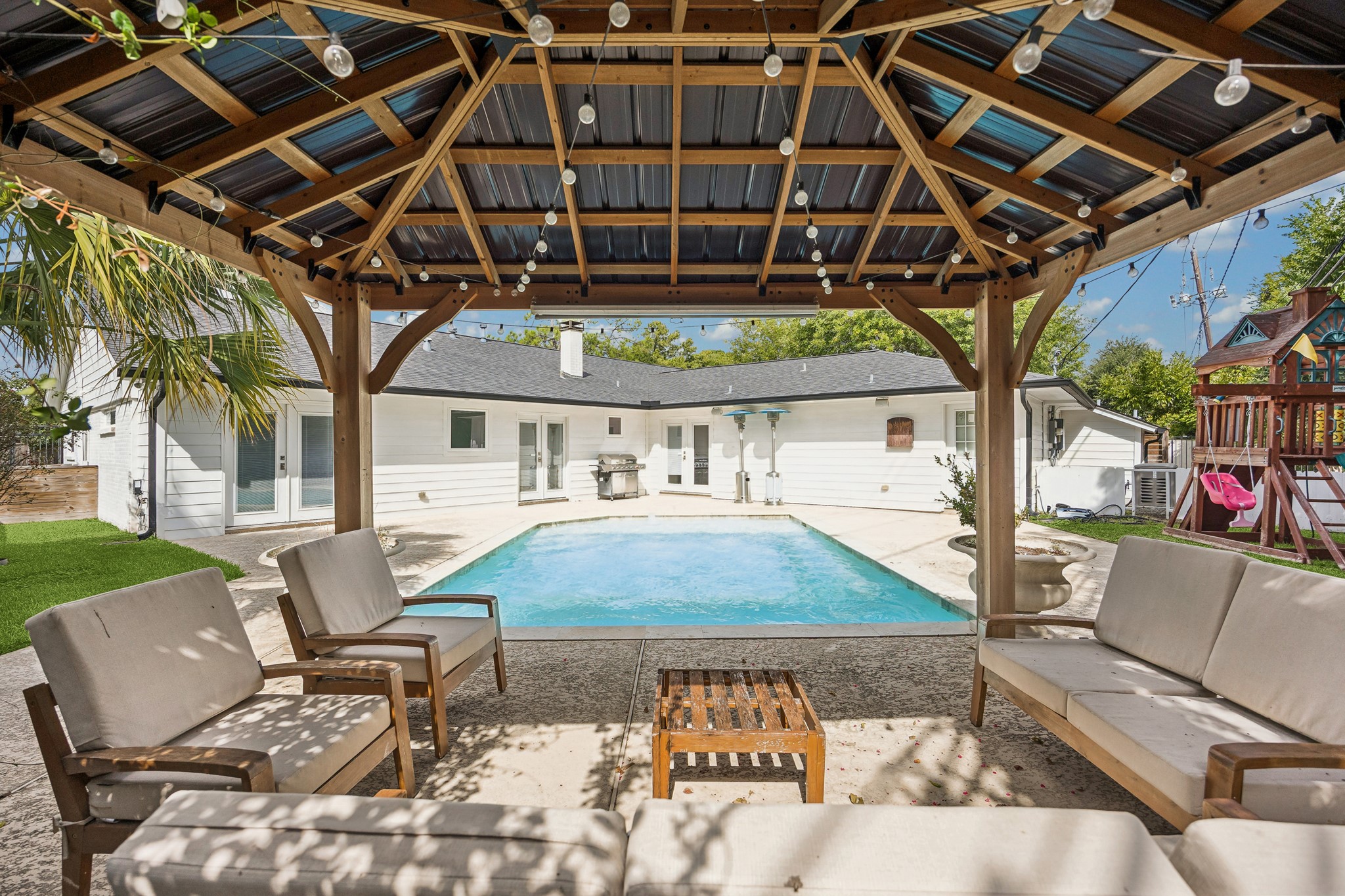Relax in the shade of the beautiful covered pavilion while enjoying views of the pool and backyard. This exceptional outdoor living space offers the perfect setting for gatherings, weekend lounging, or quiet evenings at home.