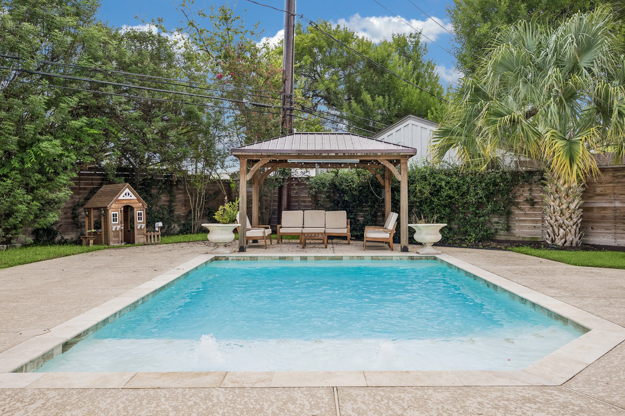 The sparkling pool creates a refreshing focal point for the backyard, while the covered pergola offers a
shaded retreat for relaxing, dining, and
entertaining. The grass area provides additional
space for children and pets to play, making the
backyard as functional for everyday family life as it is for hosting friends. Together, the pool, shaded
outdoor living area, and open lawn create a private resort-style setting designed to be enjoyed year-round.