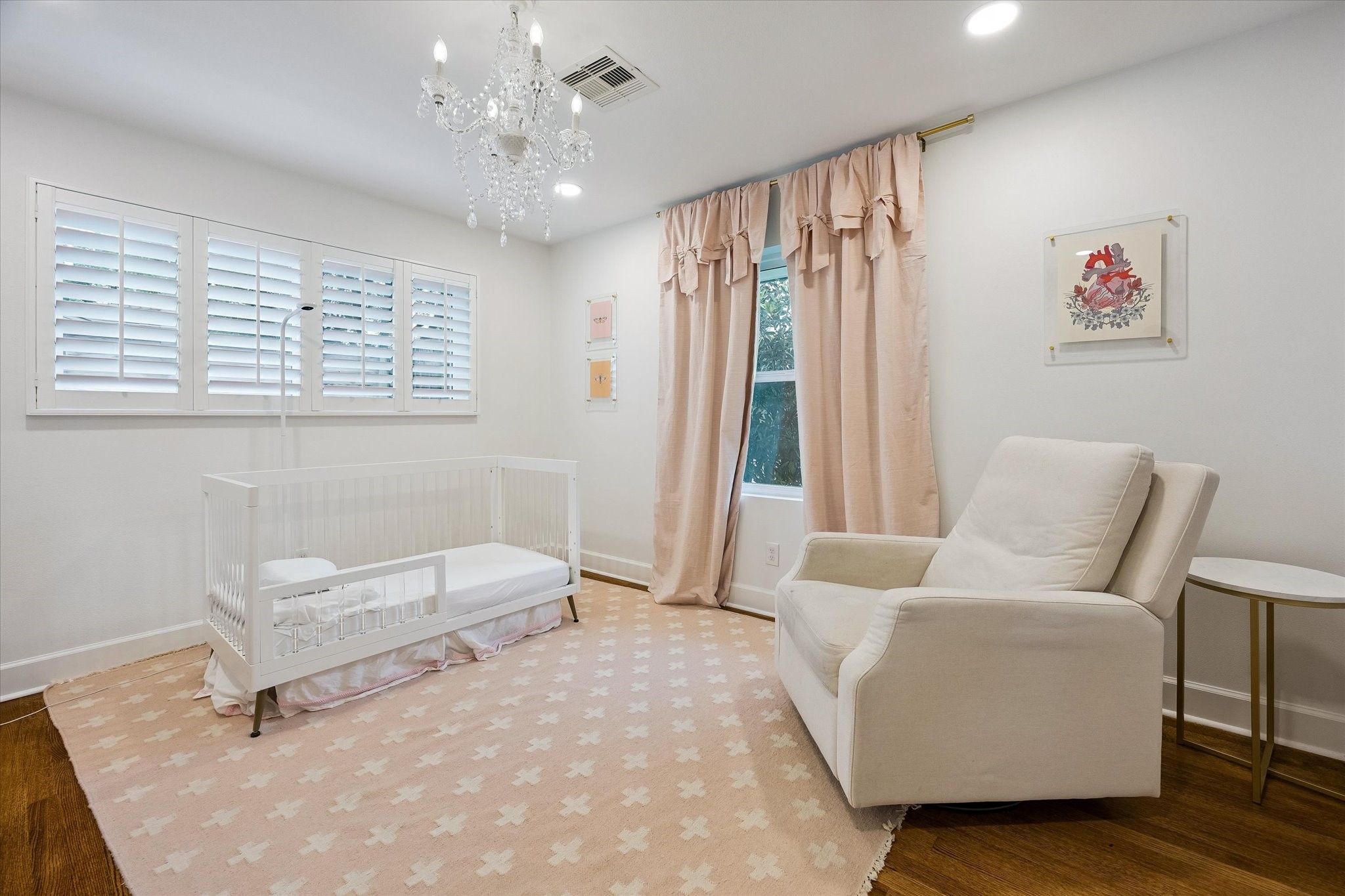 (14x11) A crystal chandelier brings an unexpected
touch of elegance to this guest bedroom, casting a
soft glow throughout the room. The thoughtfully
designed space feels every bit as refined as the
rest of the home. Draperies and rods excluded)