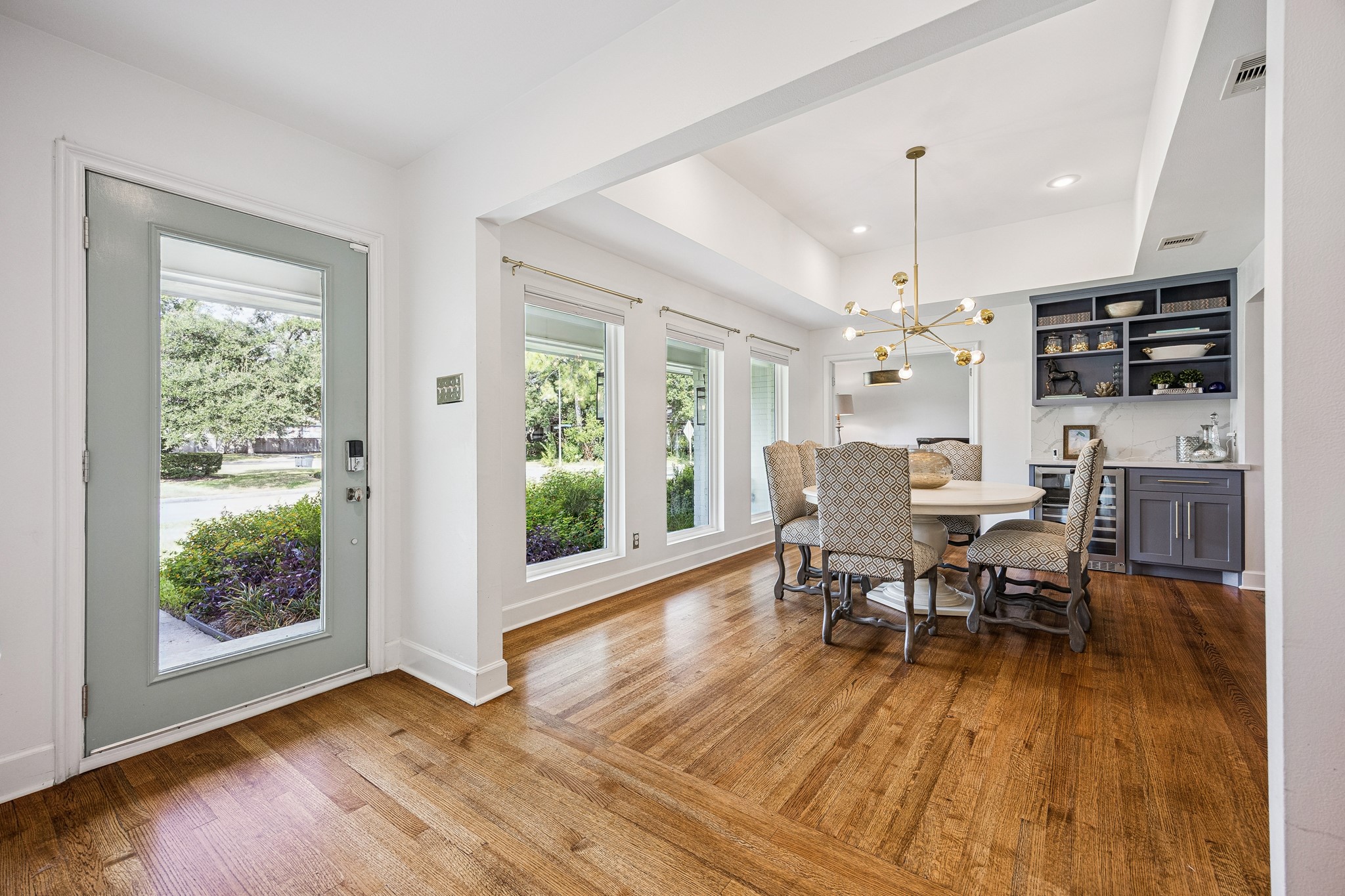 Step inside to discover beautiful hardwood floors, abundant natural light, and an inviting dining area. Large windows overlook the beautifully landscaped front yard.
