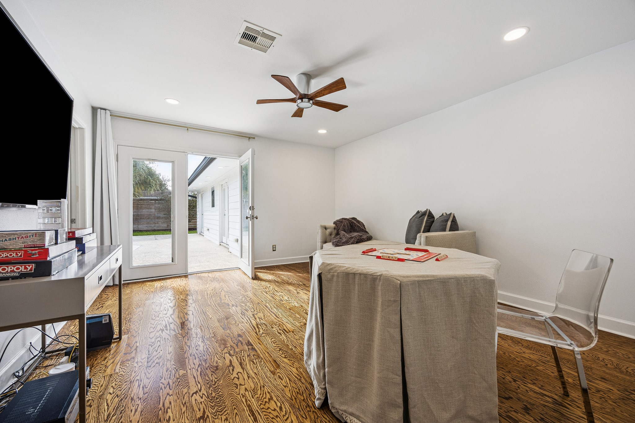 (22x9) French doors provide direct outdoor access from this guest bedroom, showcasing indoor-outdoor living at its finest. The result is a light-filled, tranquil space with effortless connectivity.