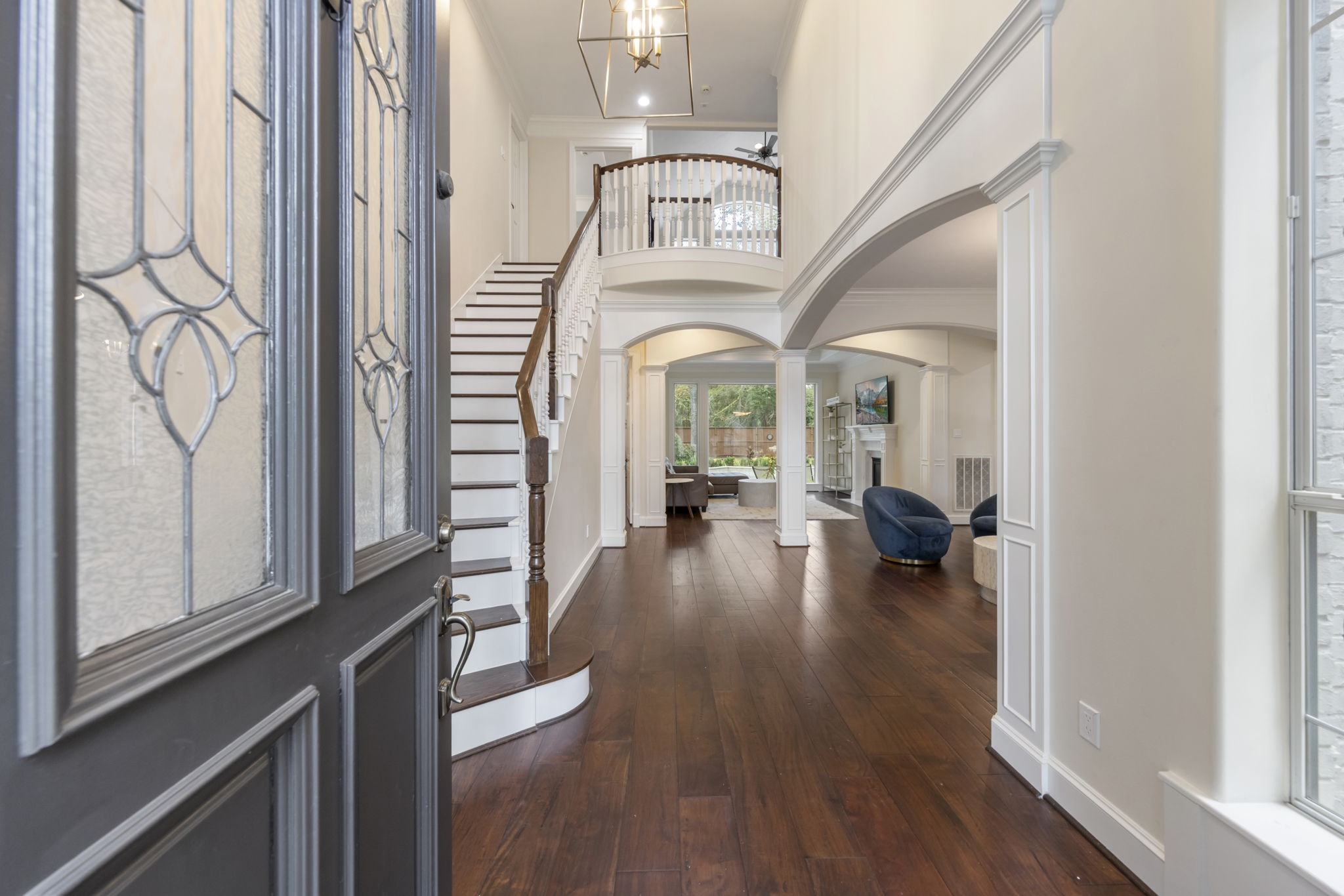 Enter to grand stairway and two-story foyer boasting ample natural light and gleaming wood floors.