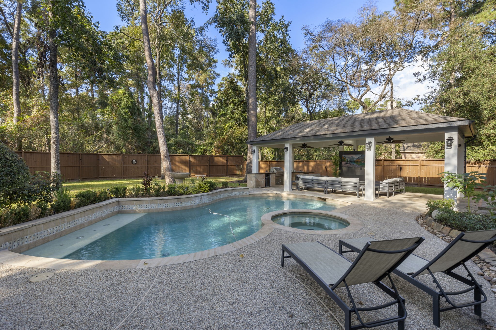This dreamy outdoor space features a rare oversized lot with an extended covered patio, summer kitchen, and a pool/spa, all with no rear neighbors for added privacy!