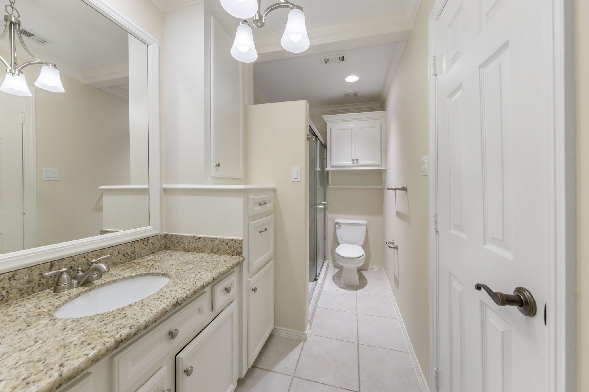 Ensuite bath boasts ample storage, granite counter tops and walk-in shower.