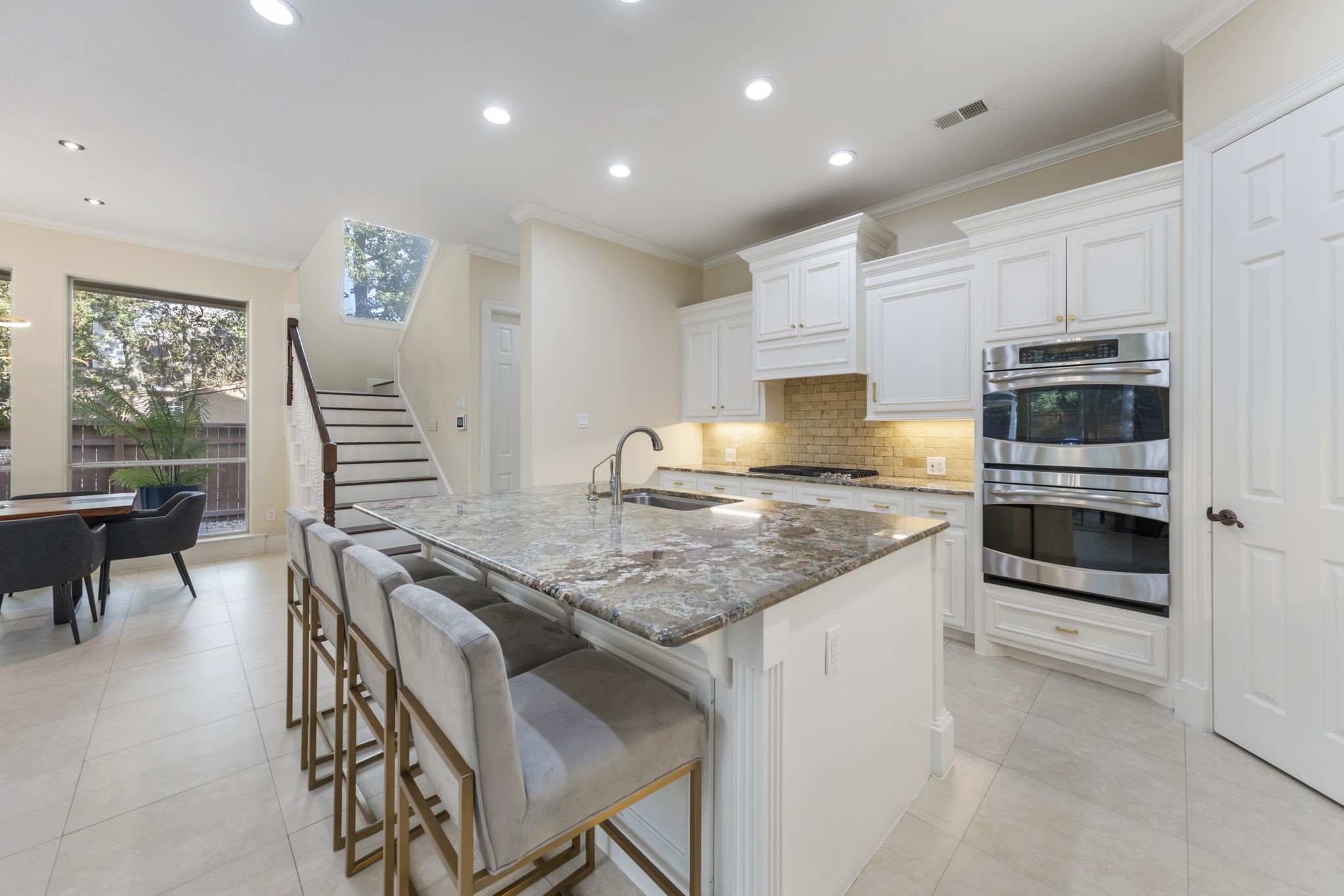 Kitchen offers light and bright cabinets contrasted with beautiful granite countertops, double oven and stainless steel appliances. BRAND NEW dishwasher is a bonus!