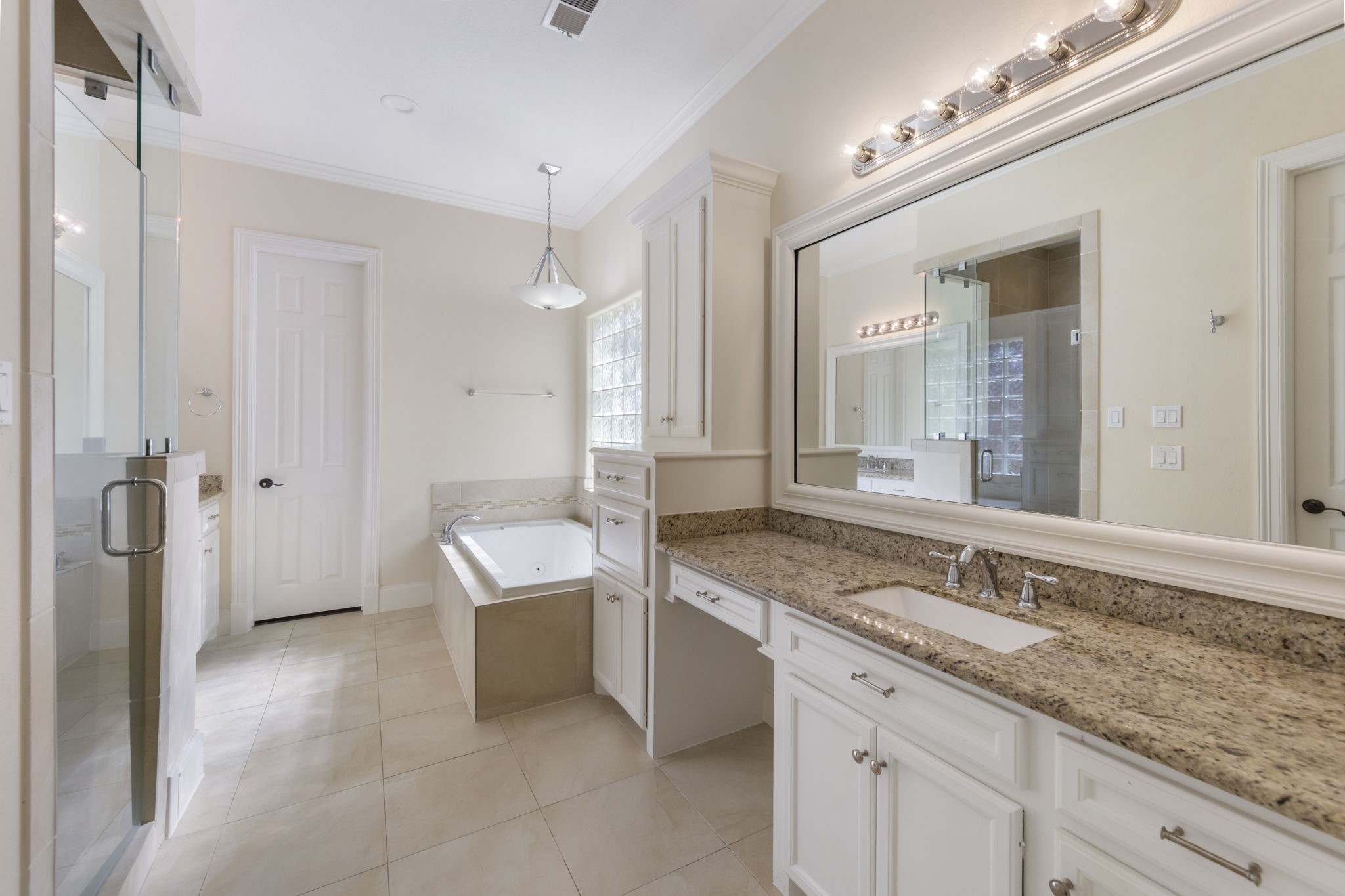 Primary bath features dual sinks, vanity, timeless granite counter tops, large walk-in shower, and soaking tub perfect to relax at the end of the day. Impressive walk-in closet is complete with built-in storage.