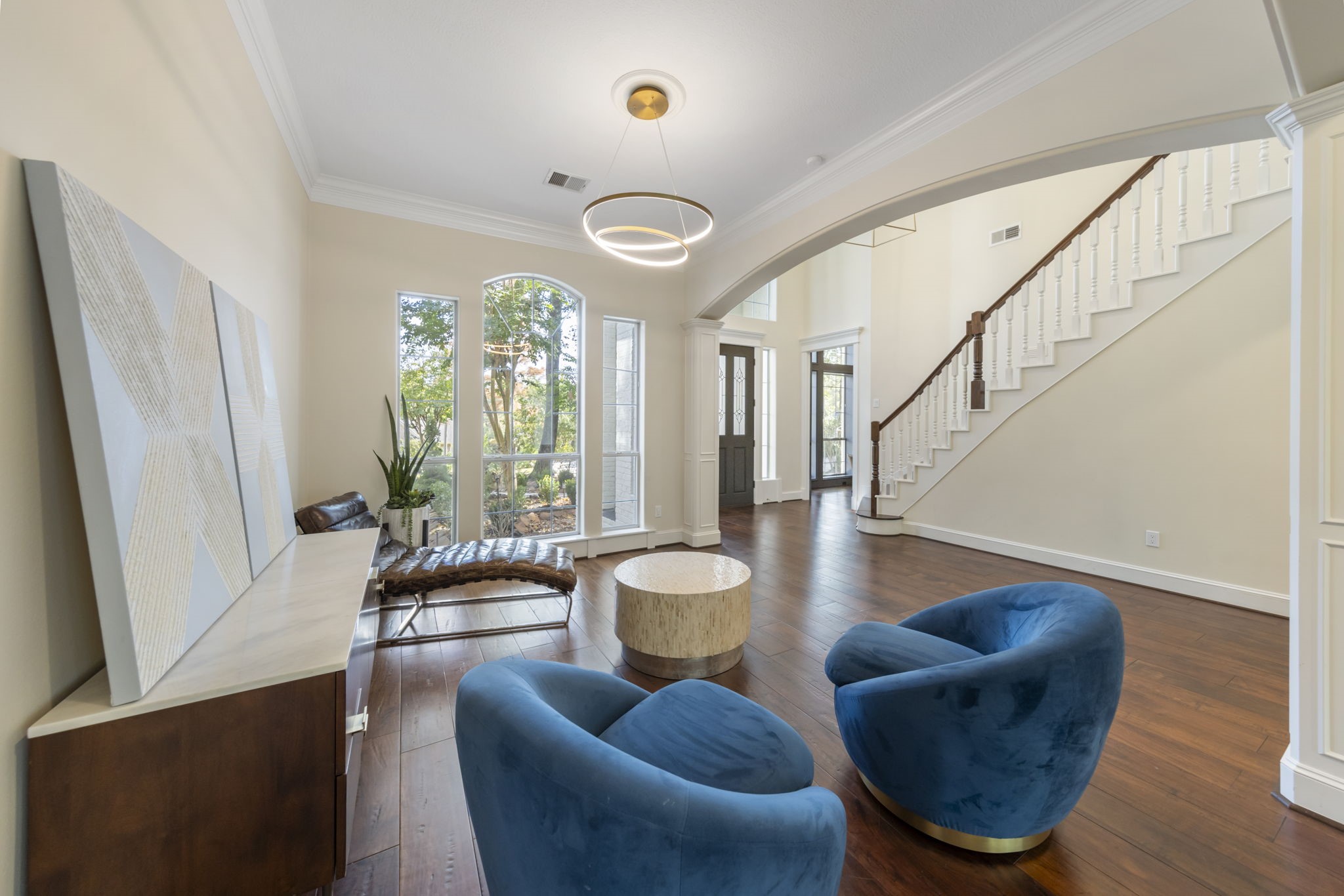 Formal dining boasts elegant crown molding with stunning views to the front of the home.