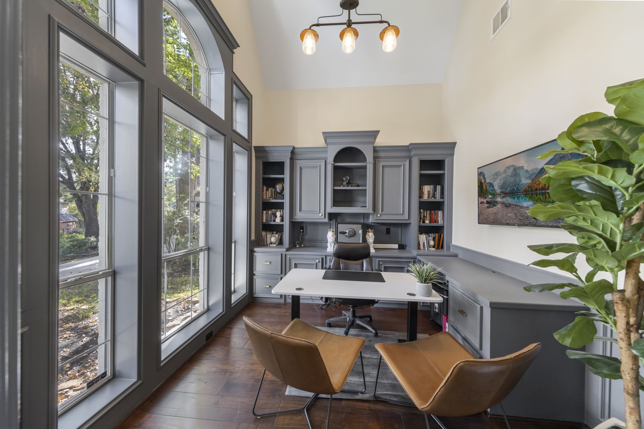 Private home office overlooking the front landscape boast soaring ceilings and freshly painted built-ins.