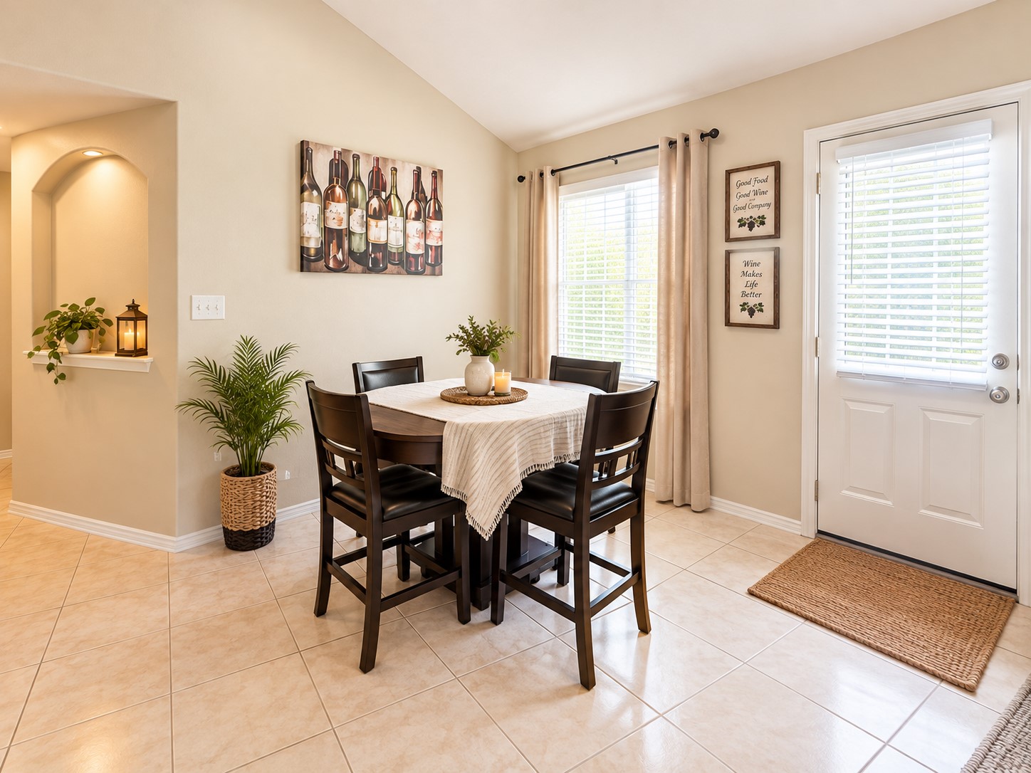 Bright dining area with a cozy table set, elegant decor, and abundant natural light from large windows, creating a warm and inviting atmosphere.
