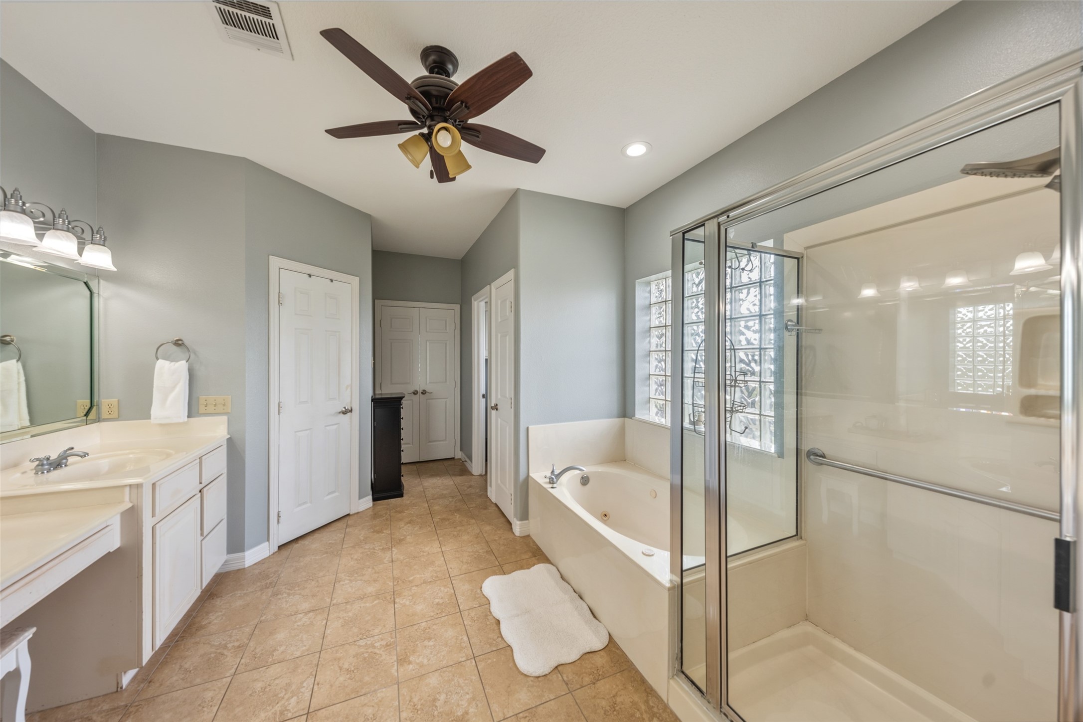 Walk in shower + his and her closets in primary
