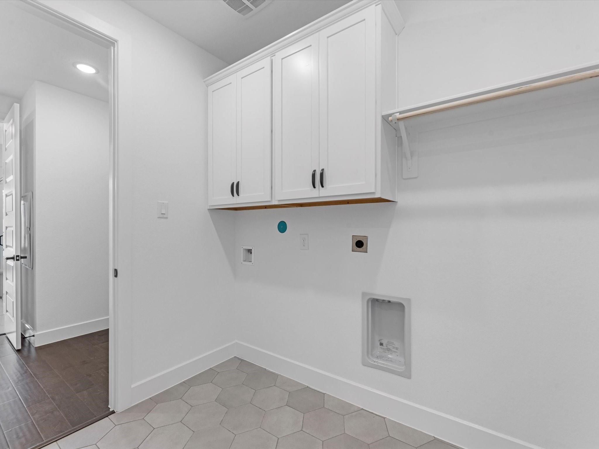 Laundry room with electric washer and dryer.