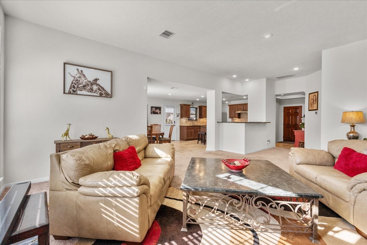The living room features a cozy fireplace and is bathed in natural morning light through an abundance of windows