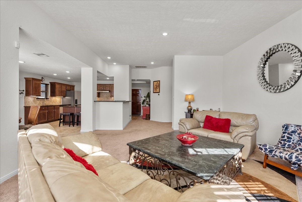 The living room features a cozy fireplace and is bathed in natural morning light through an abundance of windows
