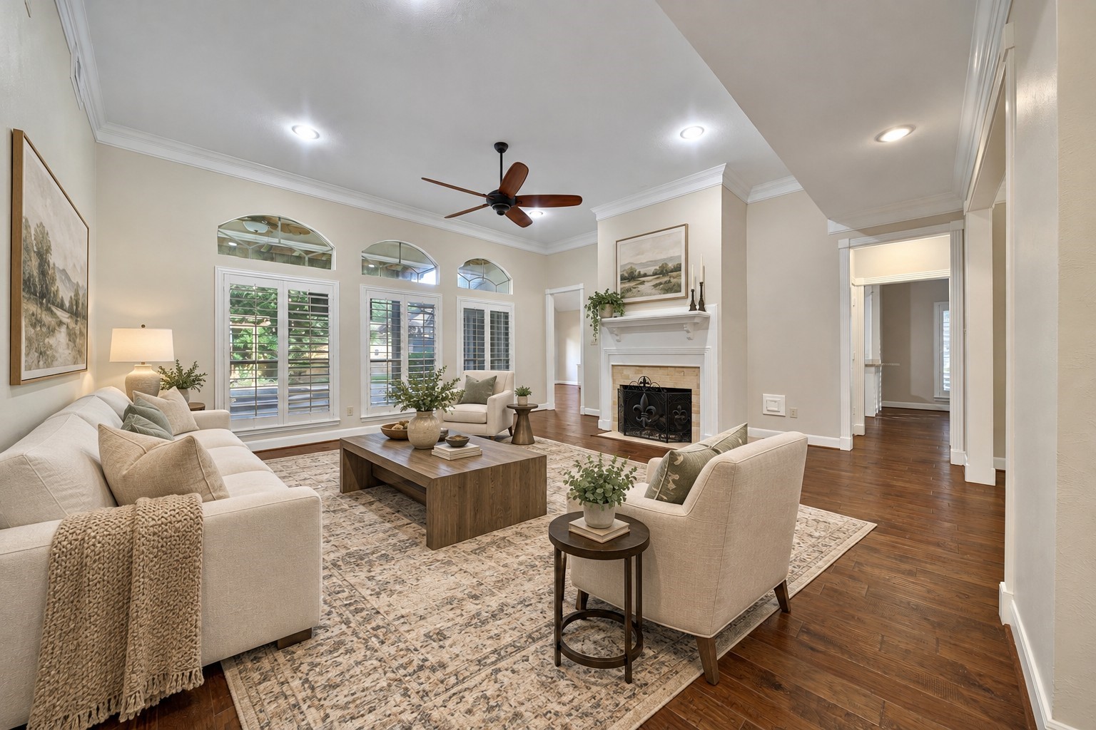 Custom millwork and beautiful hardwood floors grace this spacious room. High ceilings, large windows overlooking the patio and pool, plantation shutters, recessed lighting and gaslog fireplace make this a comfortable place to relax or entertain. Photo has been digitally altered using generative ai for virtual staging. Buyer to verify all. Custom millwork and beautiful hardwood floors grace this spacious room. High ceilings, large windows overlooking the patio and pool, plantation shutters, recessed lighting and gaslog fireplace make this a comfortable place to relax or entertain. Photo has been digitally altered using generative ai for virtual staging. Buyer to verify all.