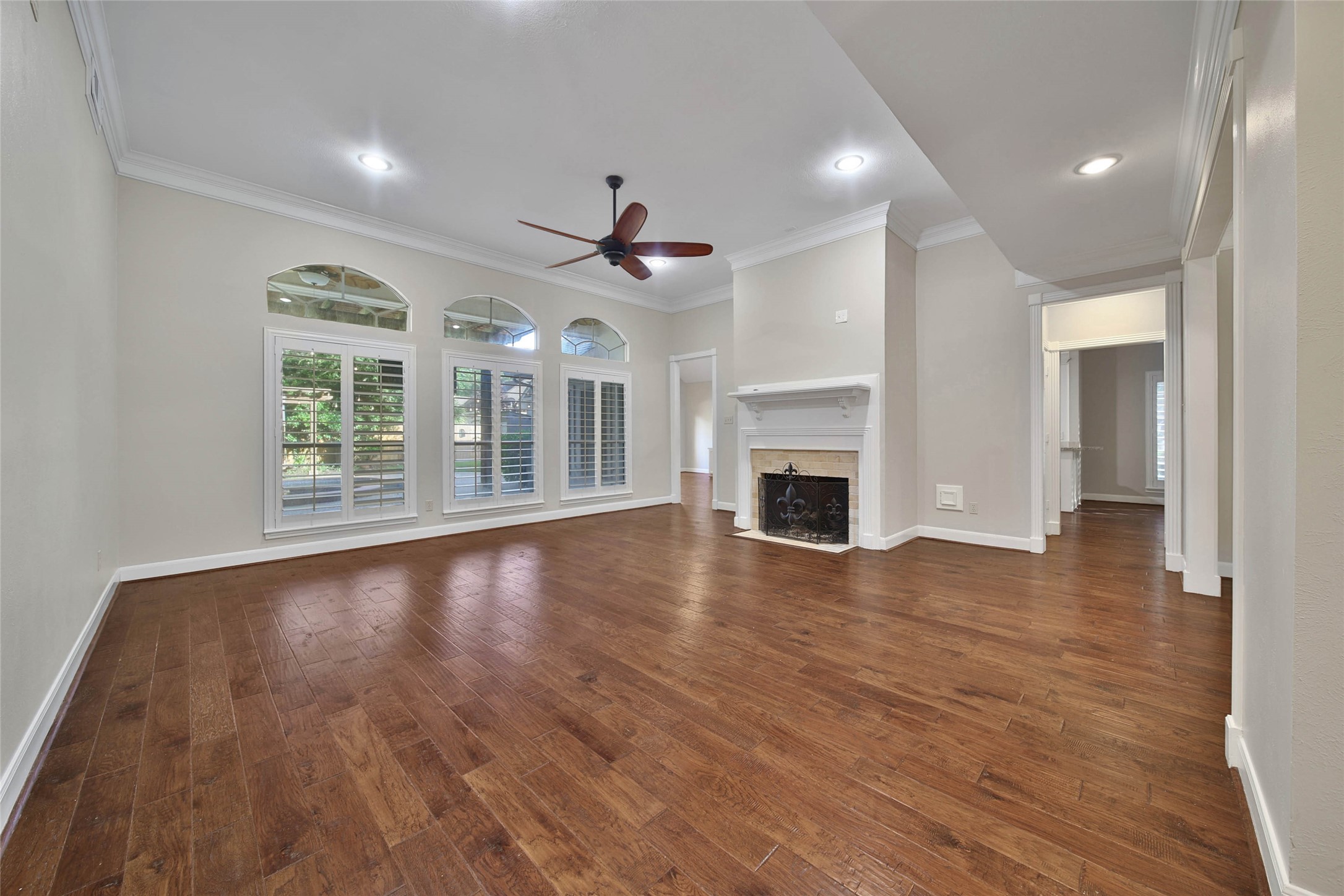 This outstanding living room showcases the beautiful hardwood floors. High ceilings, large windows overlooking the patio and pool, plantation shutters, recessed lighting and gaslog fireplace make this a comfortable place to relax or entertain. This outstanding living room showcases the beautiful hardwood floors. High ceilings, large windows overlooking the patio and pool, plantation shutters, recessed lighting and gaslog fireplace make this a comfortable place to relax or entertain.