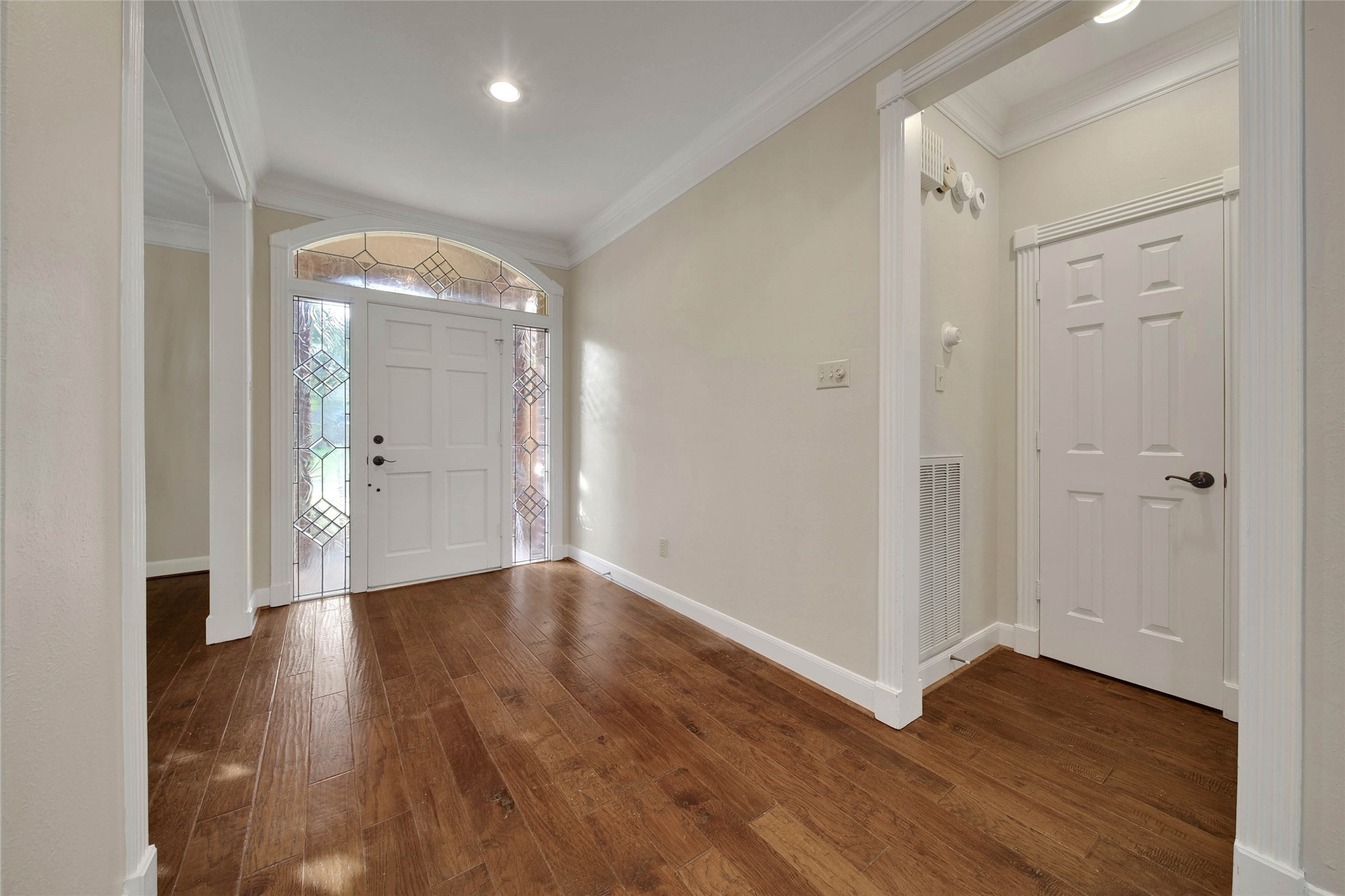 Elegant foyer with continuous hardwood floors throughout the main living area.
