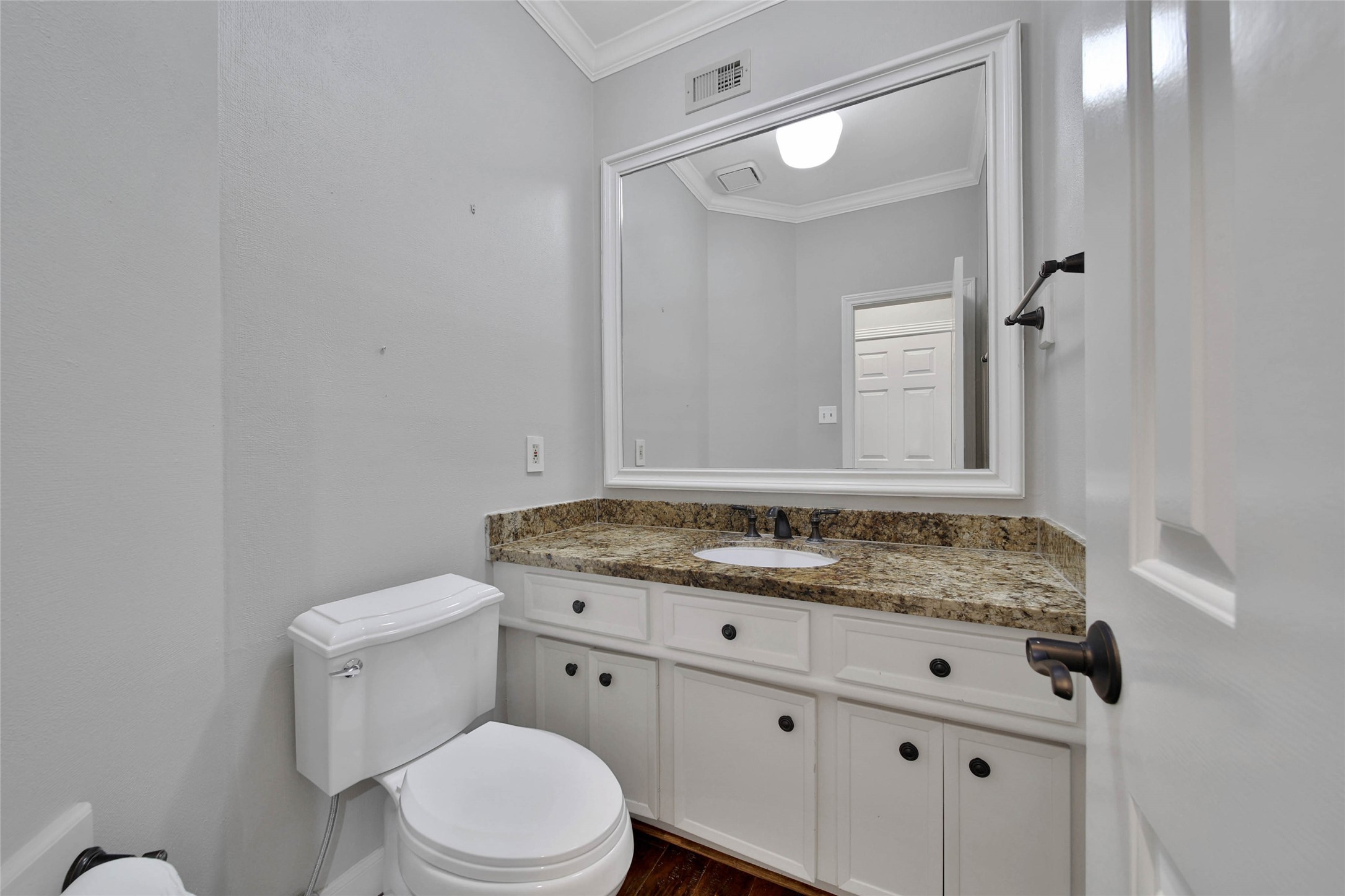 Hall bath is centrally located for access from living room, kitchen, and dining. Located in a hall between living areas.