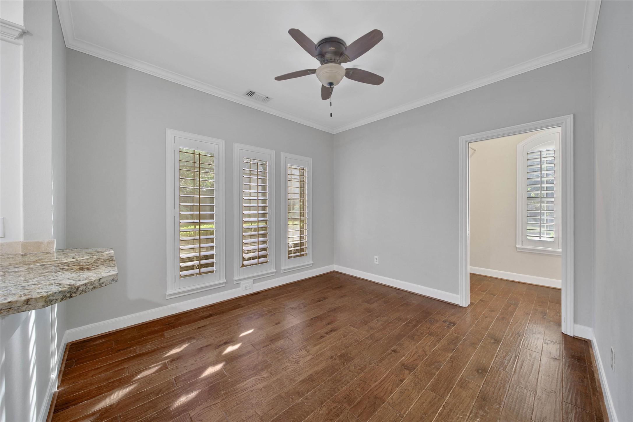 Huge breakfast room with adjacent butlers pantry / laundry utility room. Plantation shutters offer an elevated look to this functional space.